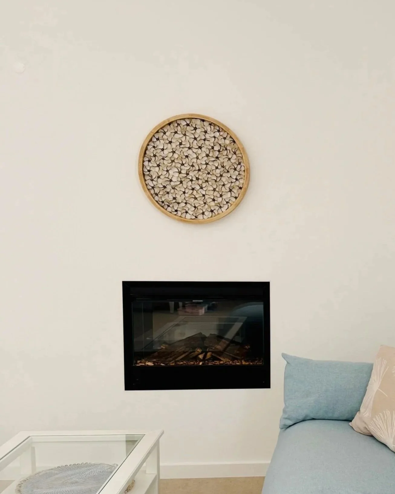 holiday home and seashell art on the wal, above the fireplace