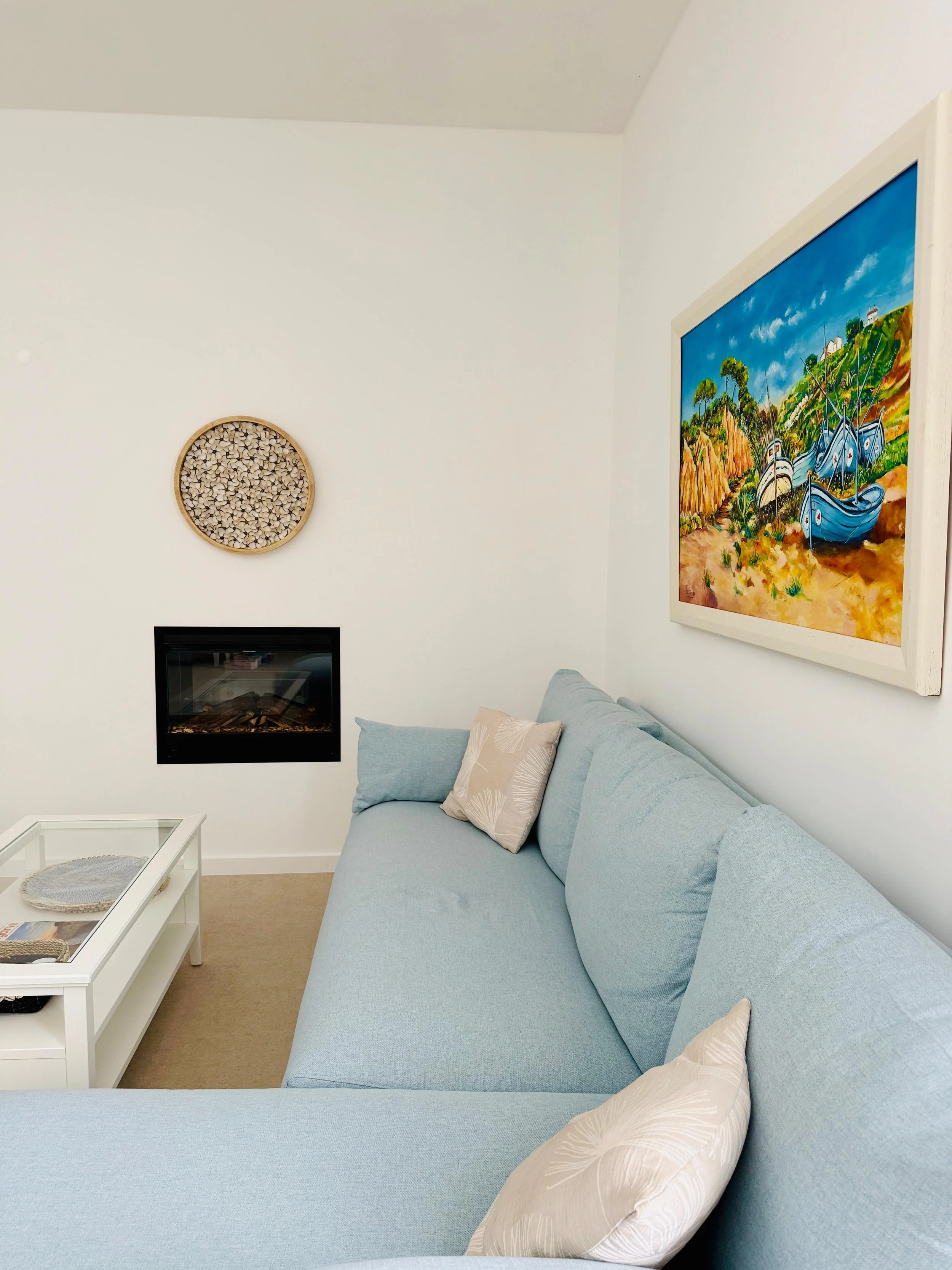 holiday home and seashell art on the wal, above the fireplace