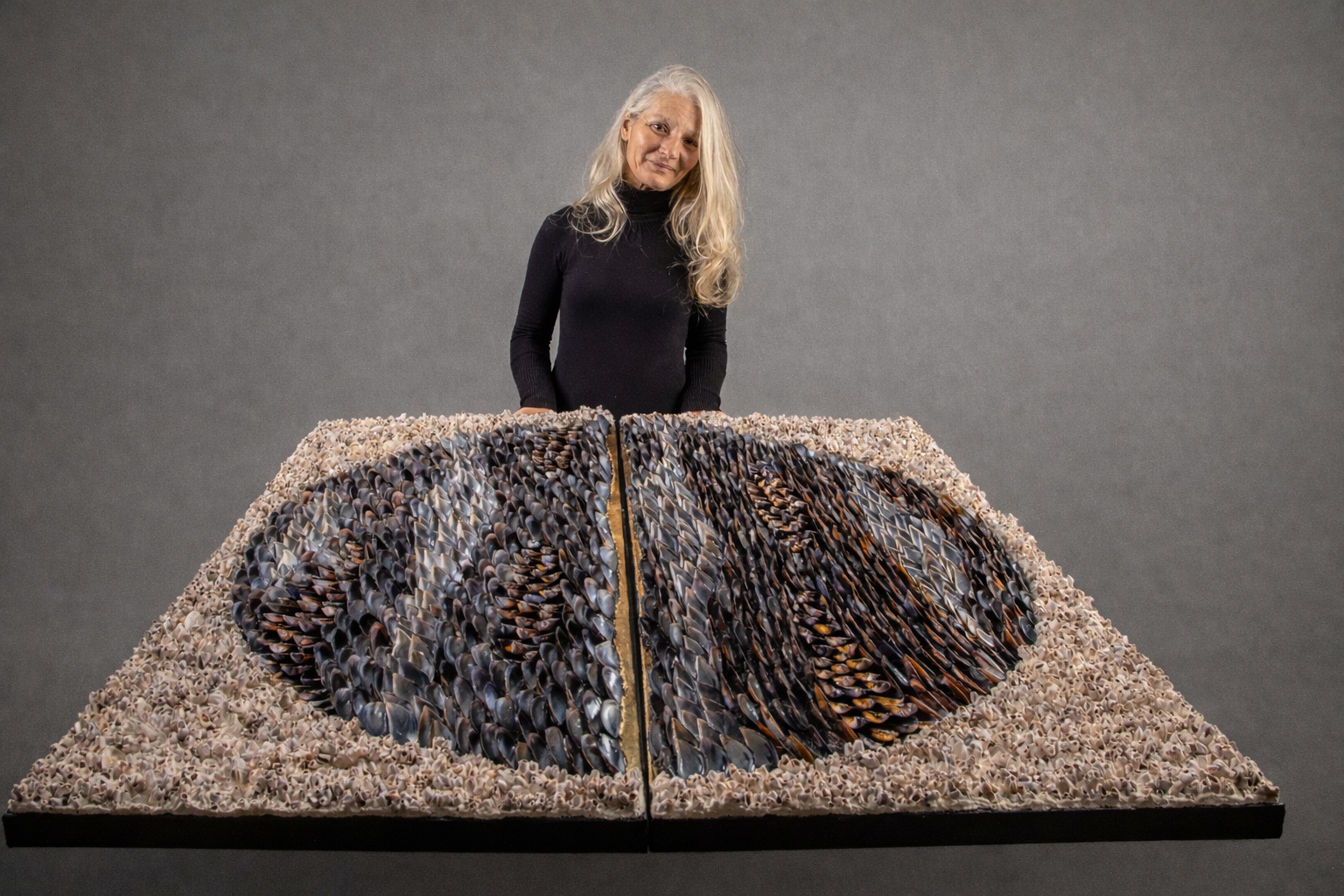 Modern sculptural shell art piece crafted from sustainably sourced mussel shells by Portugal-based artist Dana, ideal for a curated gallery space.
