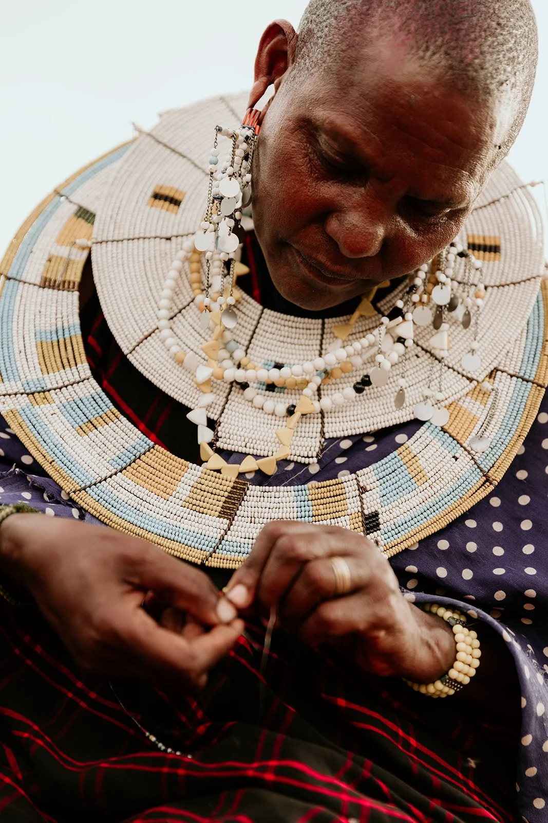 Elewana Tarangire Treetops - masai woman making beads.jpg