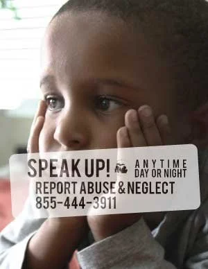 Photo of a young black boy with text overlayed that says "Speak Up! Anytime day or night, report abuse & neglect 855-444-3911"