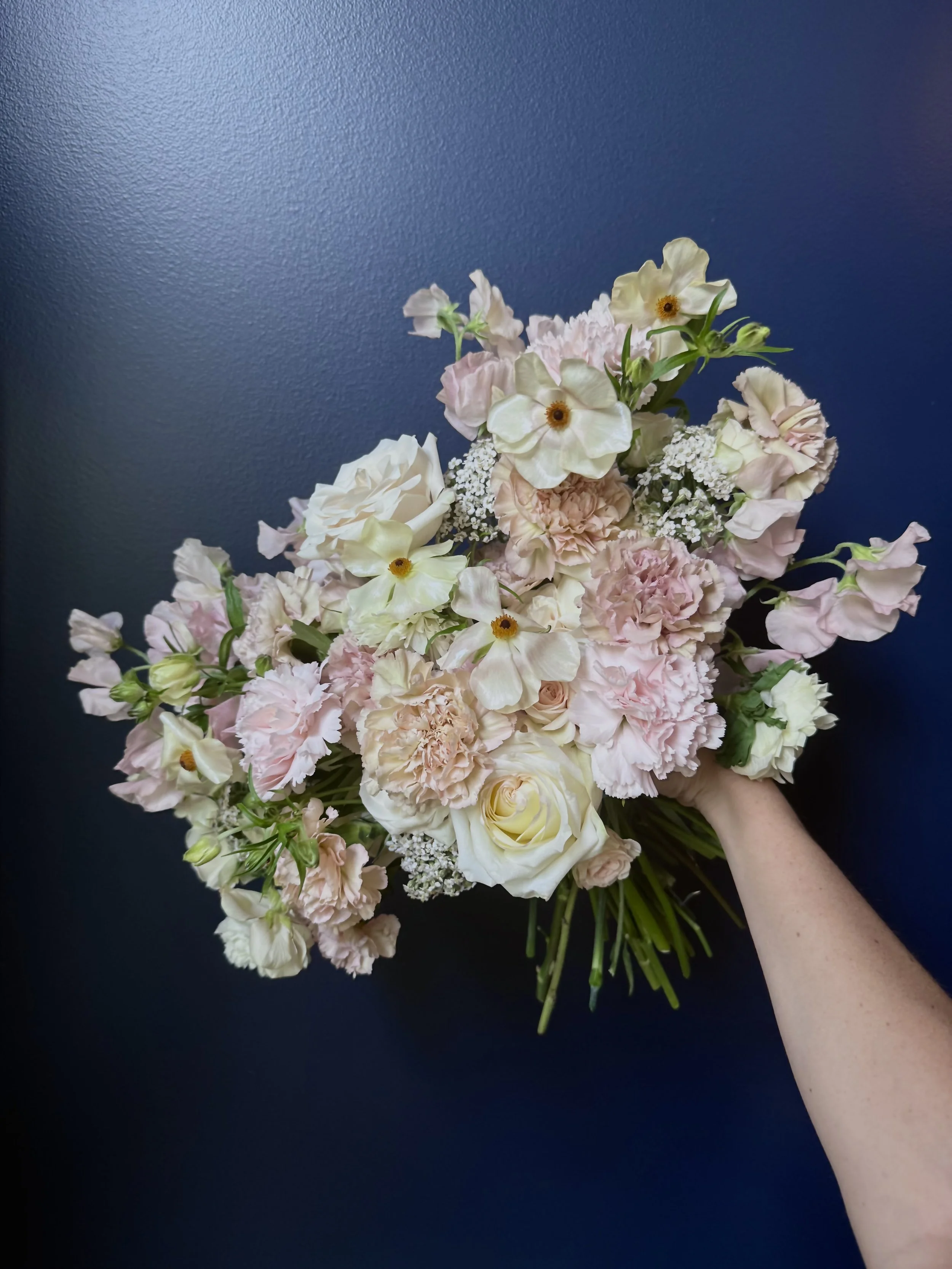 Bridal bouquet with light pink flowers, roses, carnations, and stock by Delilah’s Flower Shoppe in Statesboro & the Coastal Empire.