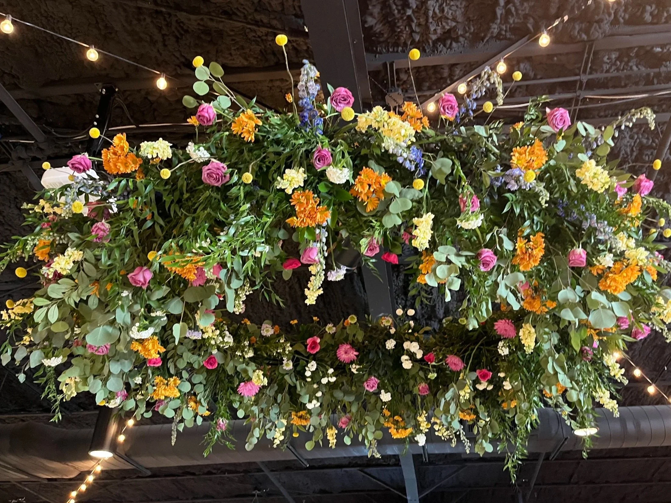 Spring floral hoop installation with greenery and assorted spring flowers by Delilah’s Flower Shoppe in Statesboro & the Coastal Empire.