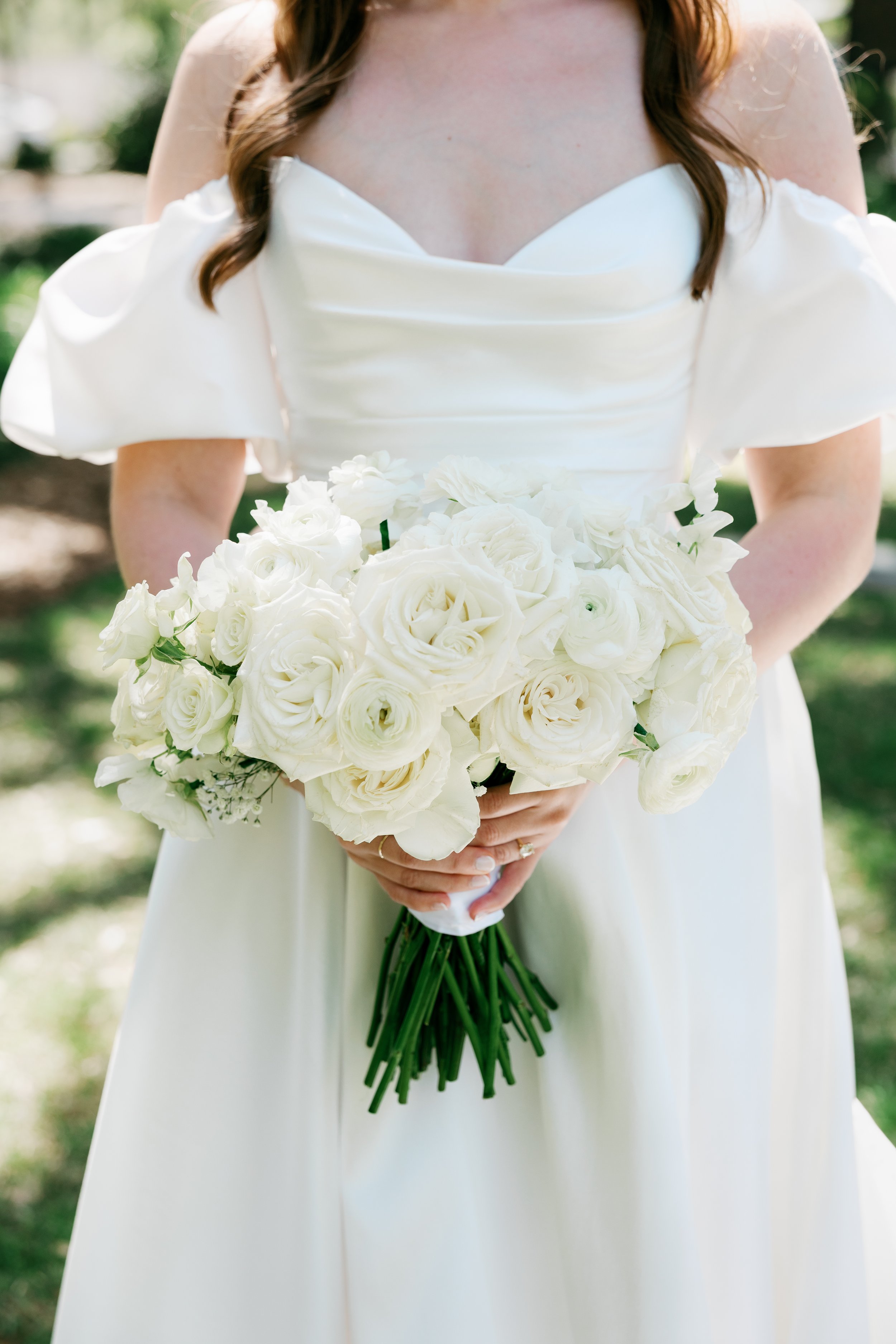 Bride and groom exchanging vows beneath a lush garden-inspired floral ceremony arch designed by Delilah's Flower Shoppe, serving Savannah, Statesboro, and the Coastal Empire.