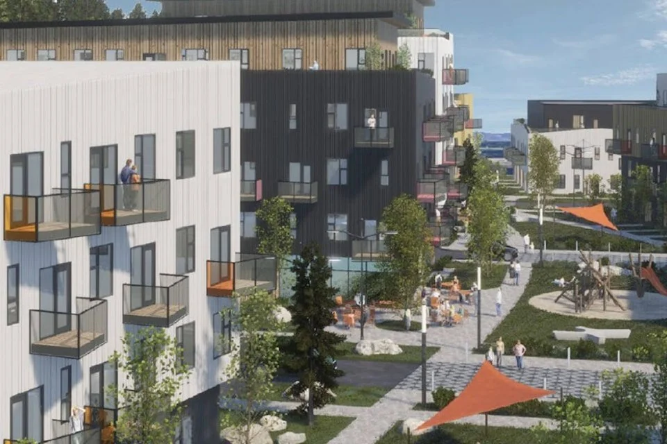 View of a modern residential complex with white and black apartment buildings featuring small balconies. There is a landscaped courtyard with trees, walking paths, outdoor seating, and a playground with swings and slides. People are walking and relaxing in the outdoor space.