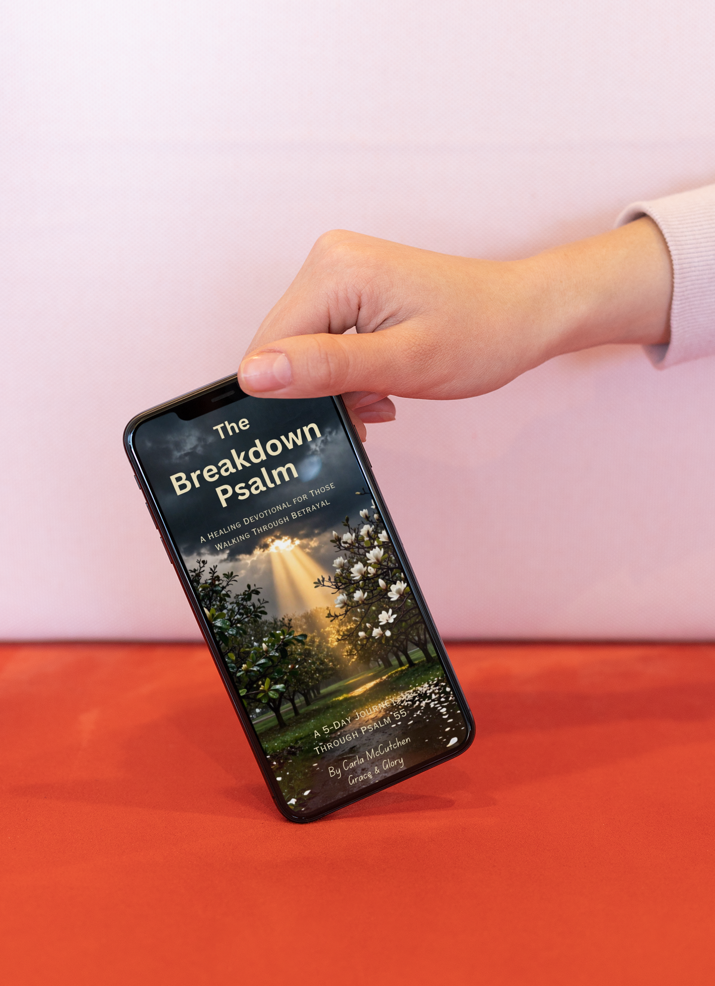 mockup-featuring-a-girl-s-hand-holding-an-iphone-xs-by-the-upper-corner-25438.png