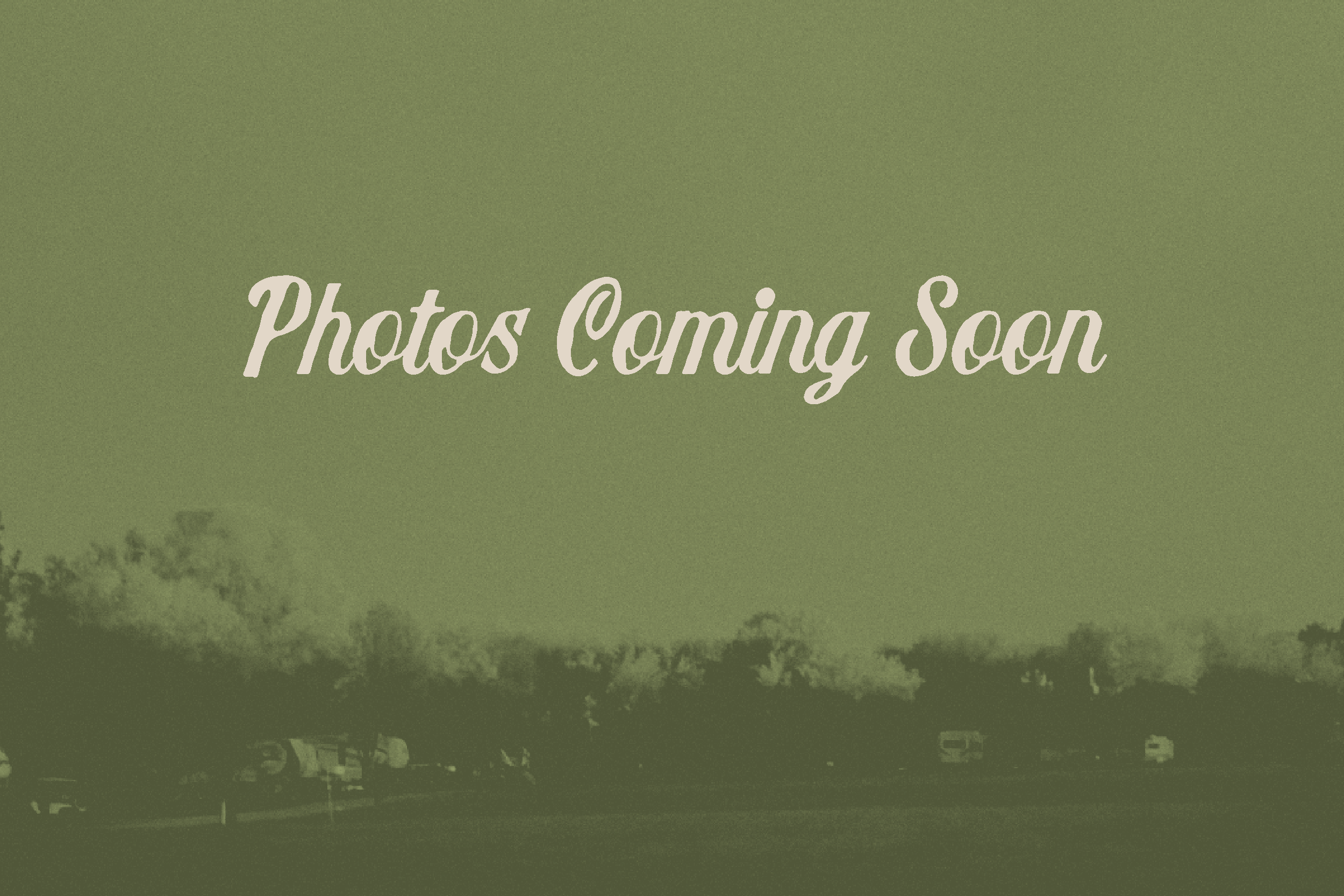 Green background with trees and parked cars, overlayed with white text that reads 'Photos Coming Soon'.