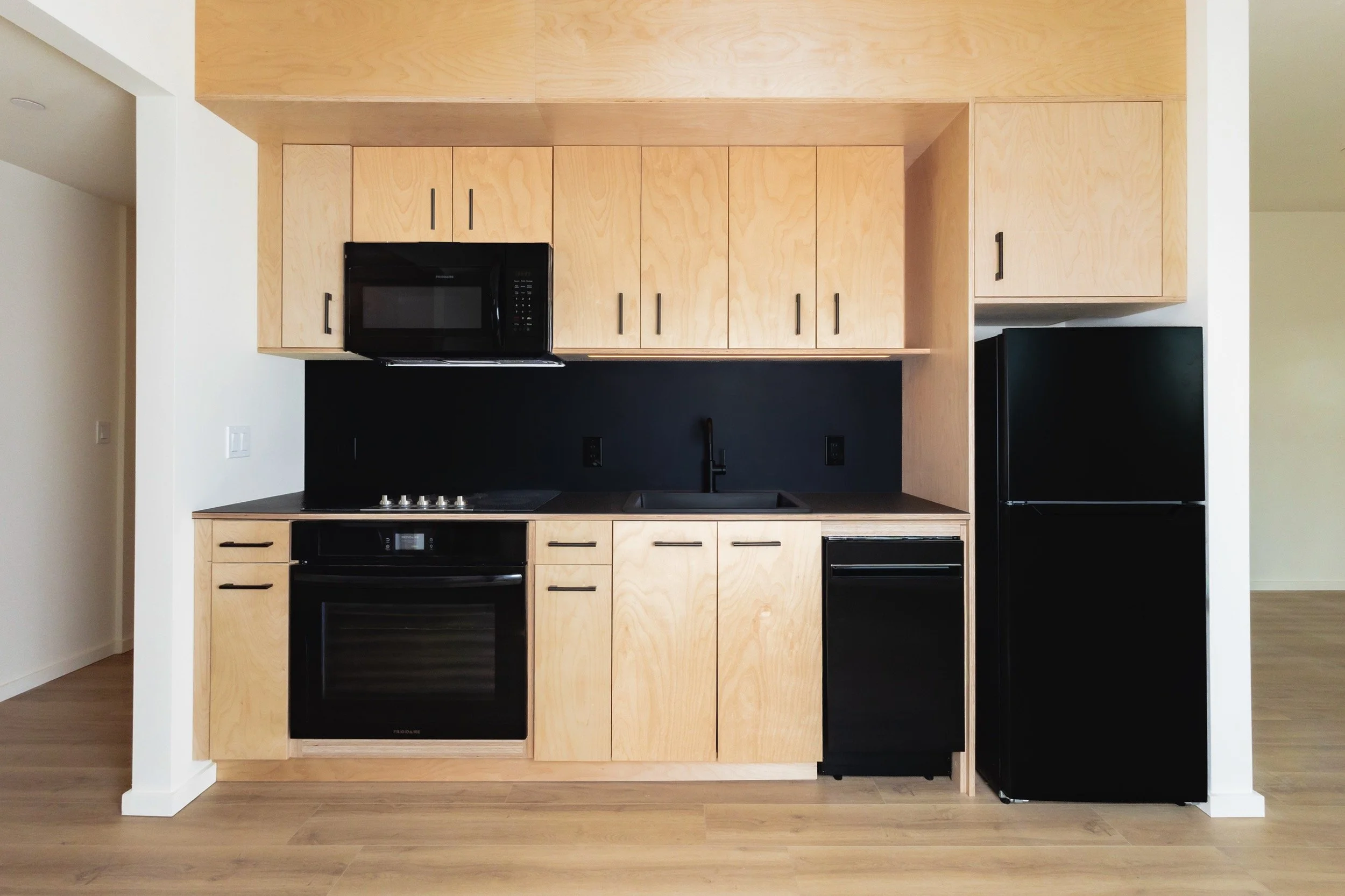 Kitchens feature Richlite countertops, a solid surface material made from recycled paper and resin, sustainably manufactured in Washington state by a hometown Tacoma company.