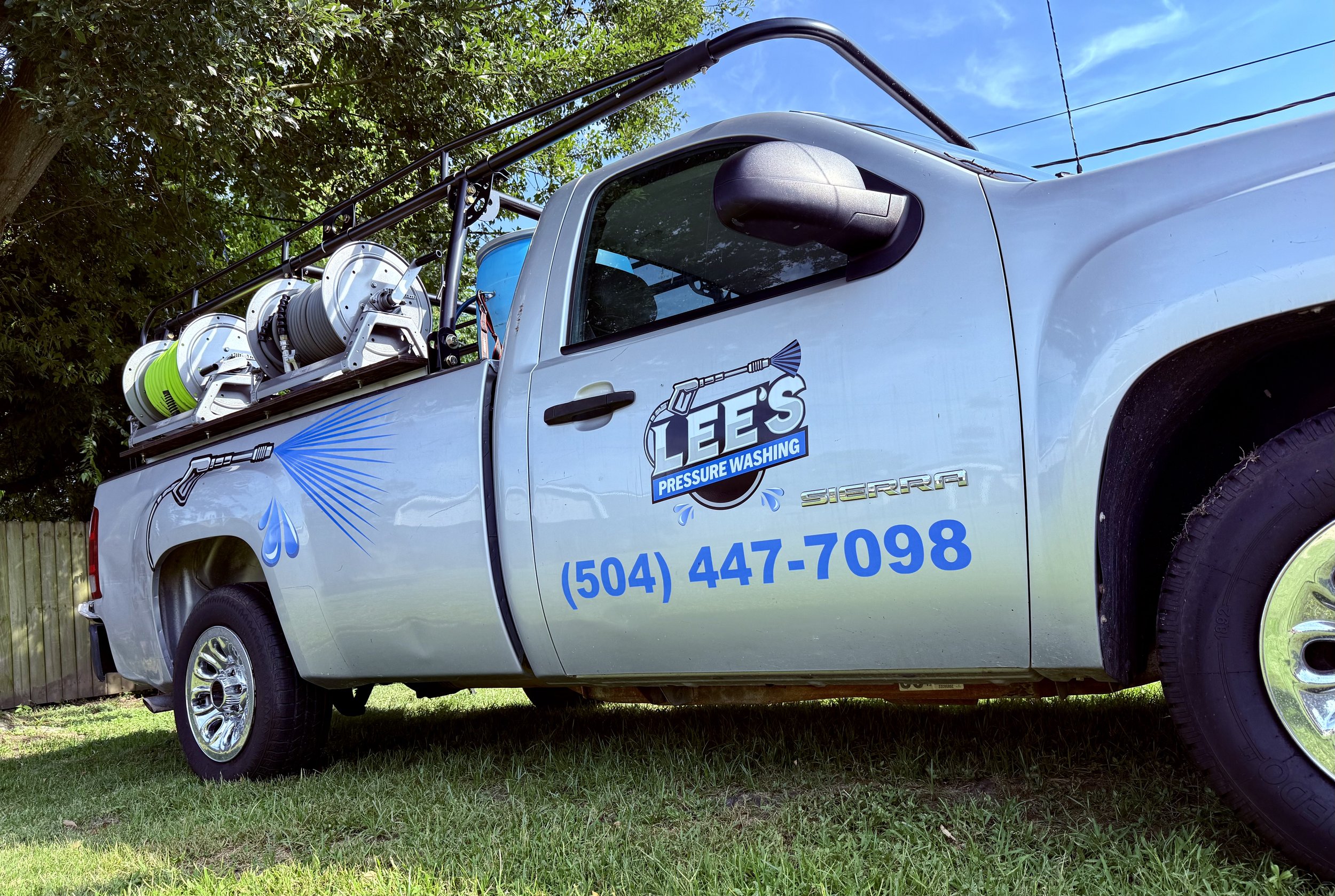 Lee's Pressure Washing service truck carrying professional-grade equipment.