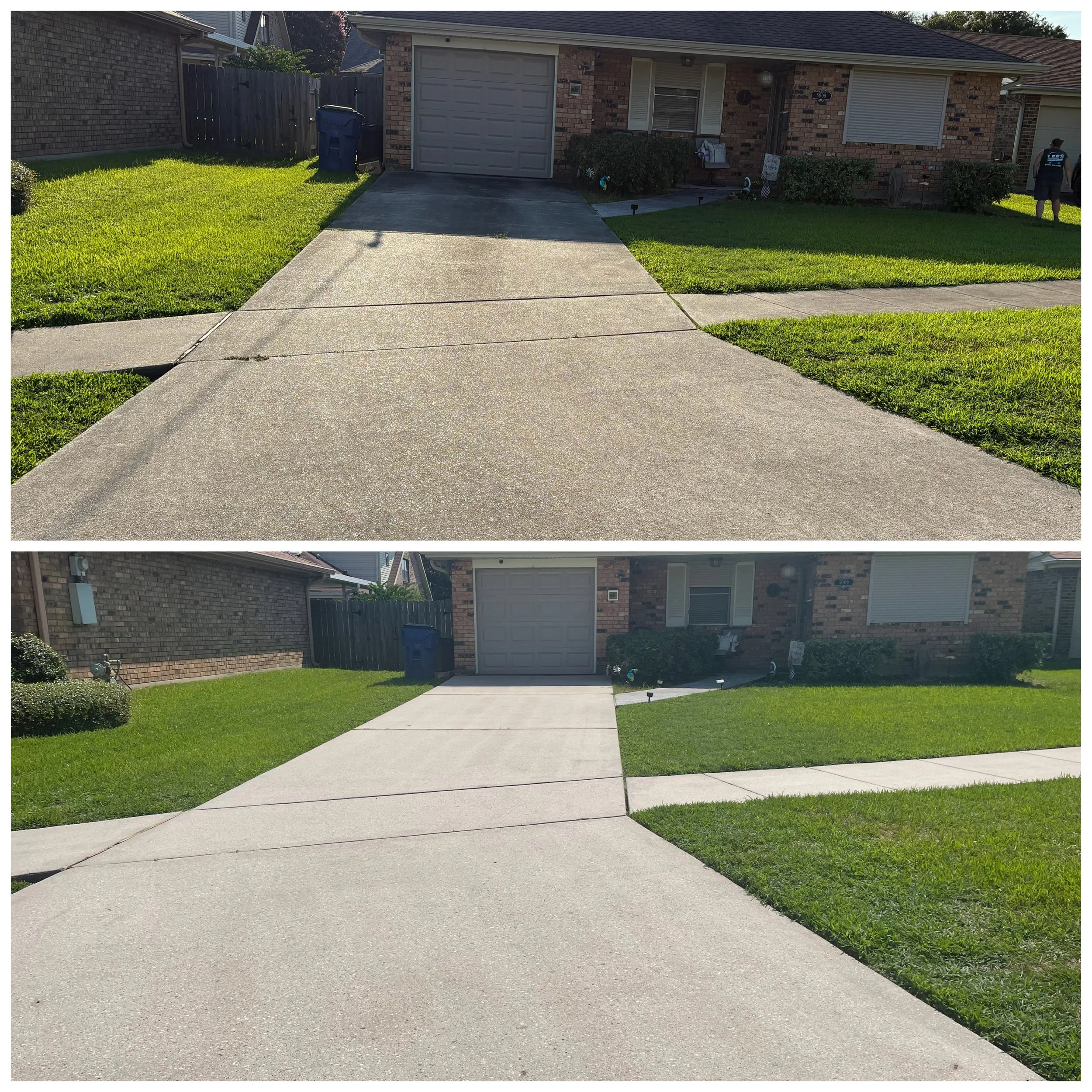 Front yard of a house with a concrete driveway, green grass, bushes, and a brick house with a garage door and window blinds.