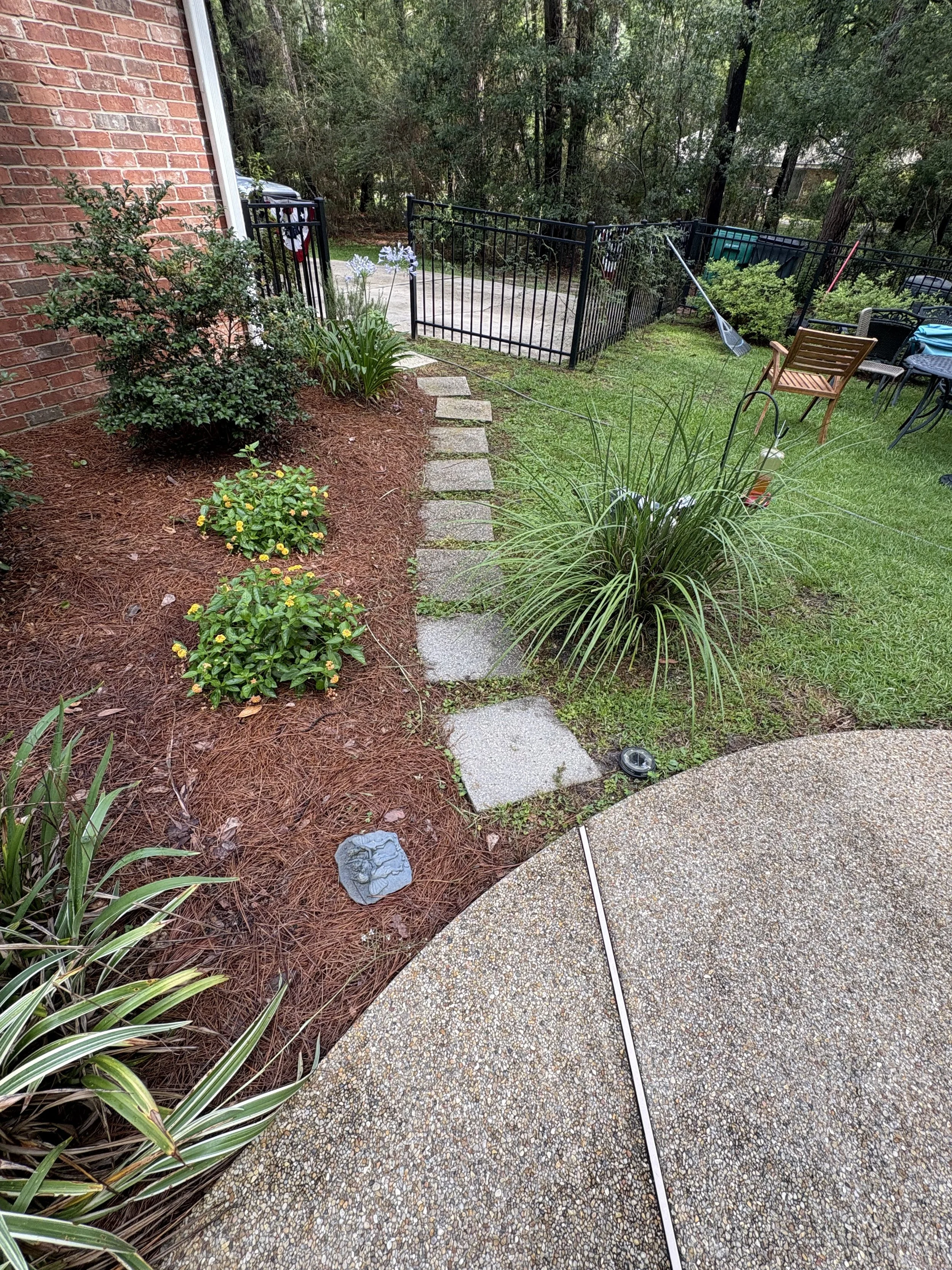 A photo of a concrete paver walkway in Slidell, LA, beautifully restored to its original color after removing deep-seated black mold and grime using professional pressure washing.