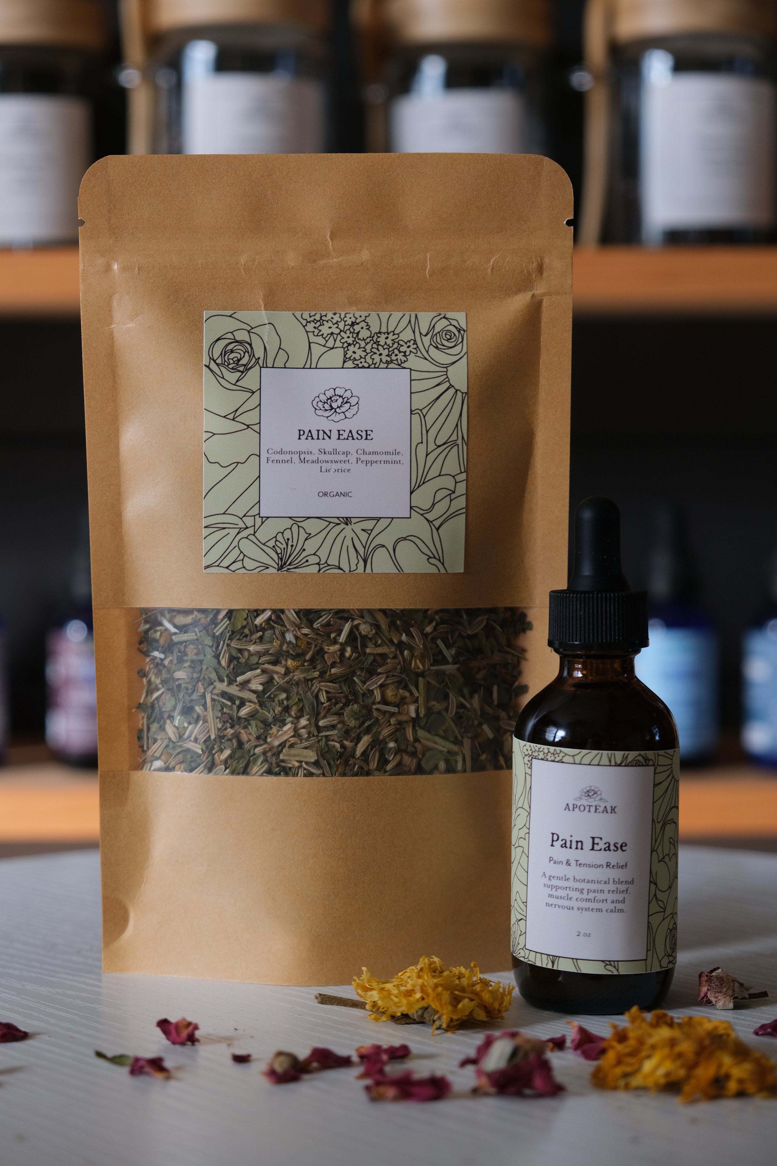 Herbal tea blend and tincture in brown paper bag and amber tinted glass bottle for pain relief