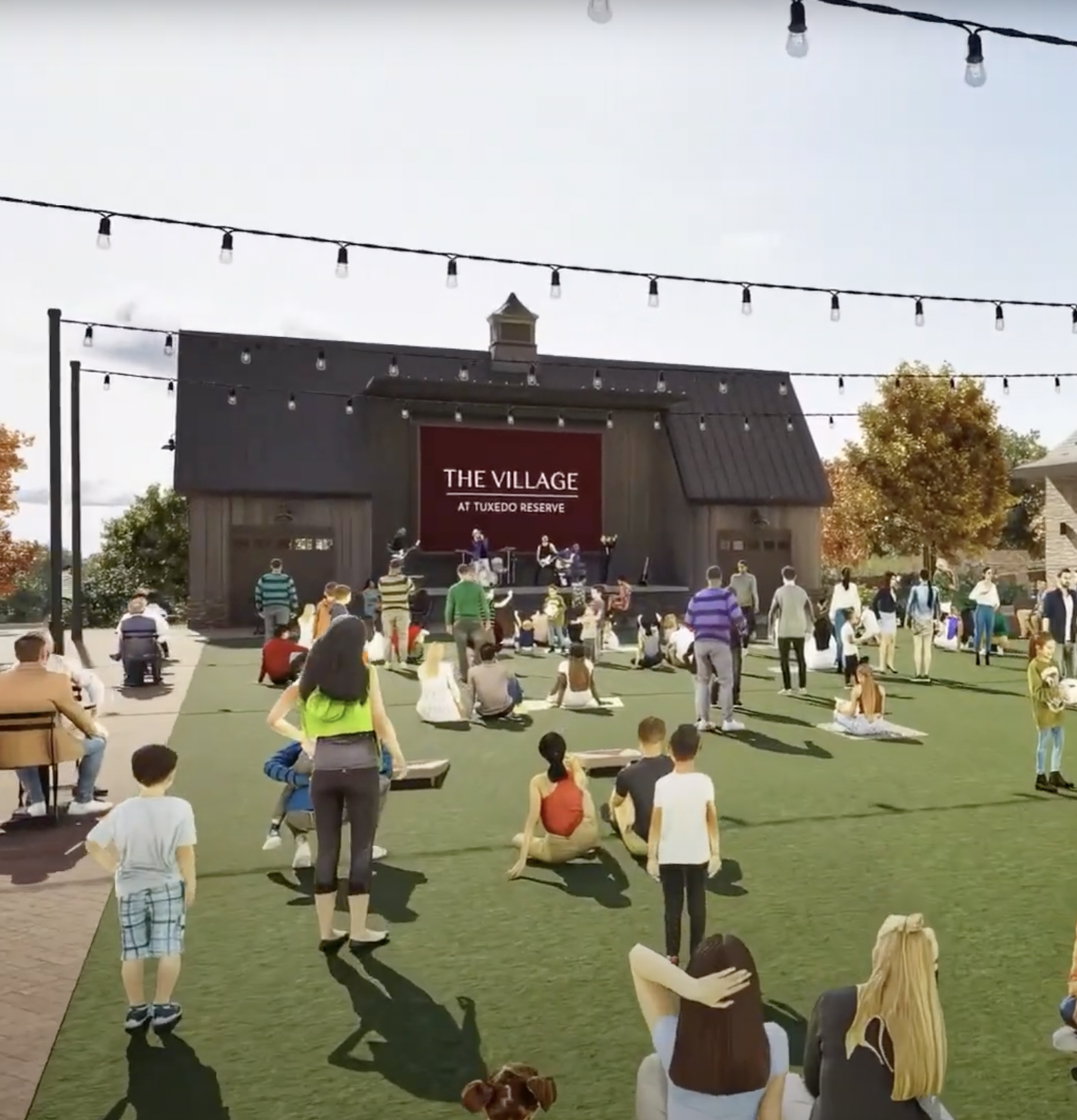 People gathered outdoors at Tuxedo Reserve enjoying a live music performance on a stage with a sign saying "The Village."