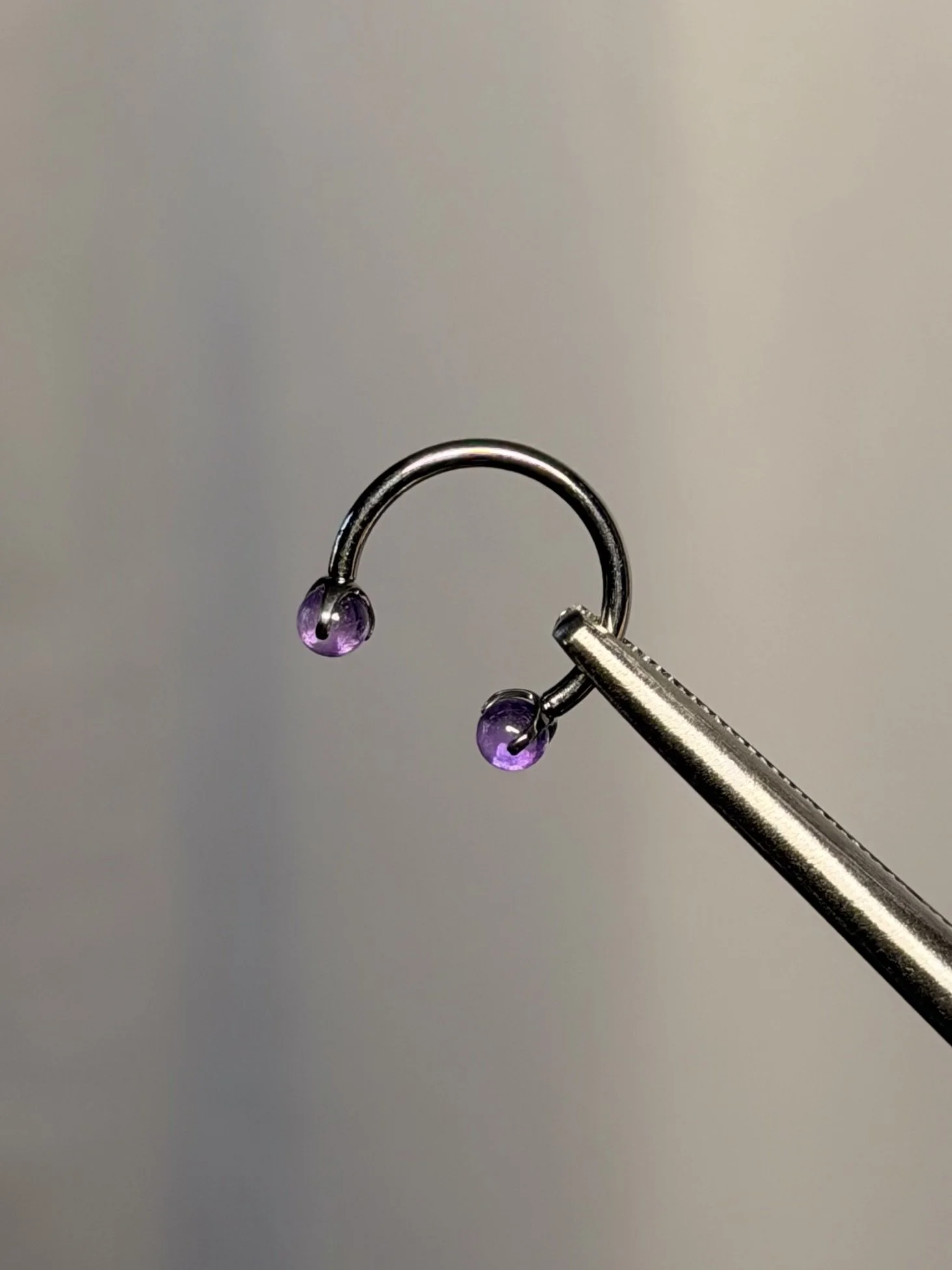 Implant grade Titanium internally threaded silver horseshoe barbell ring with luminous purple stone jewelry upgrade