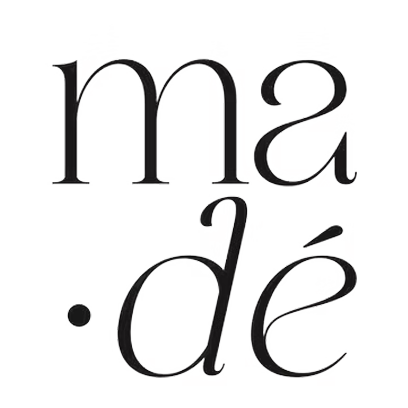 Close-up of the text 'ma de' in black, stylized font on a white background.