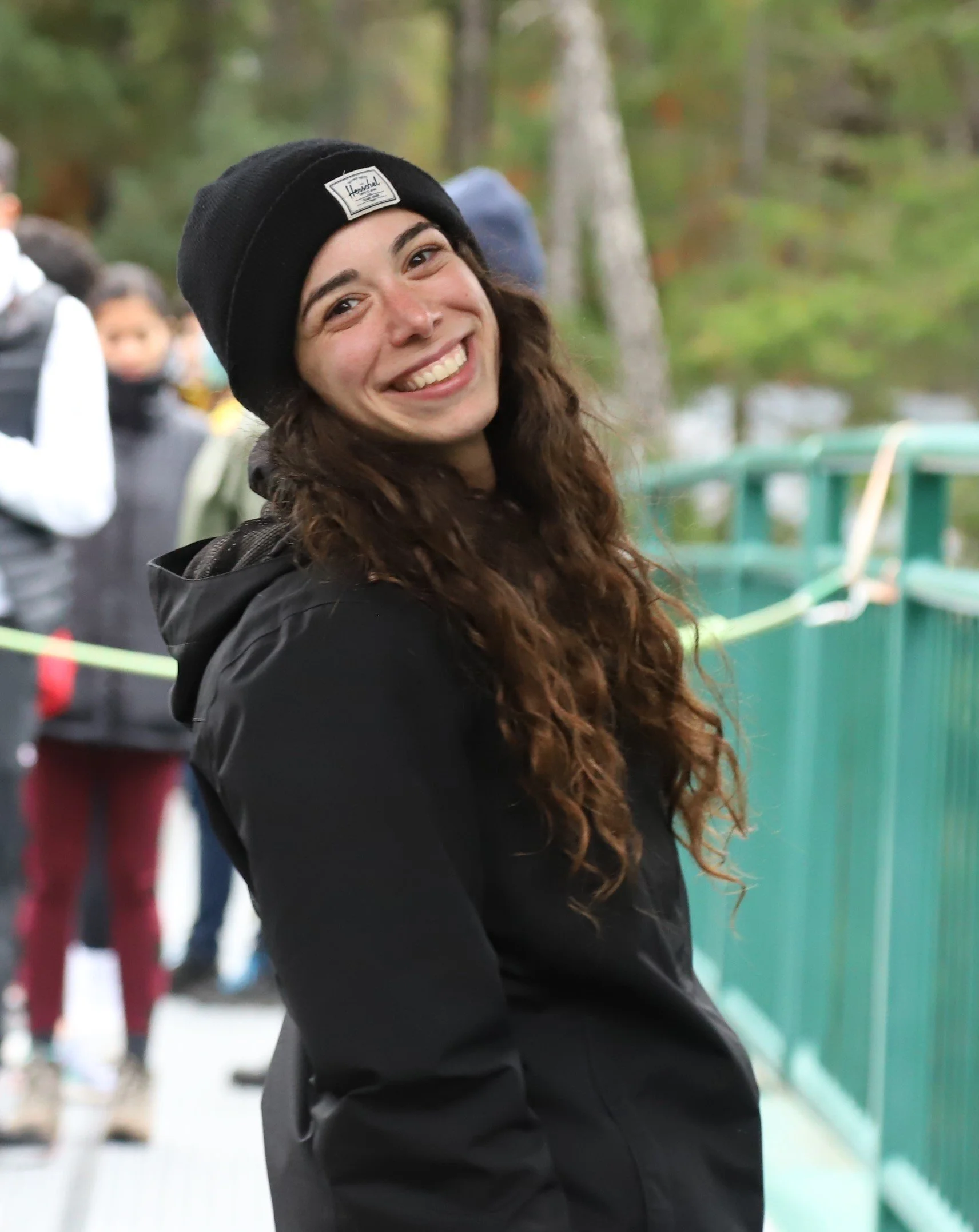 Dara Lebenger on a bridge smiling at the camera.