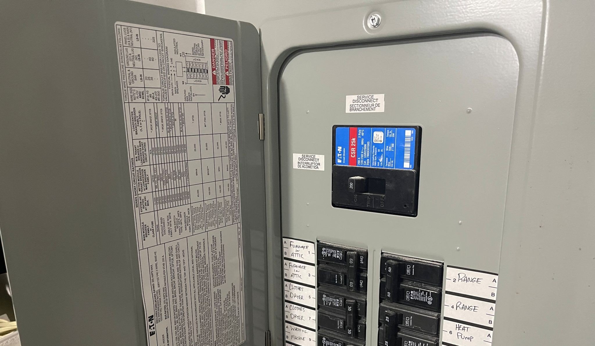 Licensed electrician performing a 200-amp service panel upgrade and breaker box replacement.