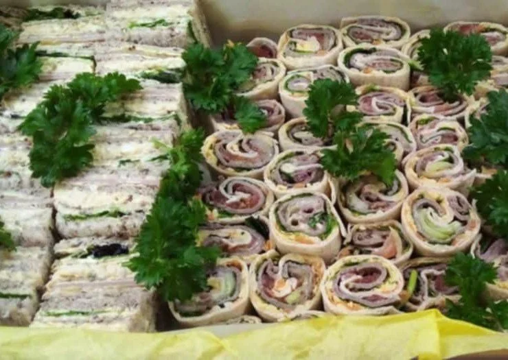 Platter of assorted pinwheel sandwiches garnished with parsley