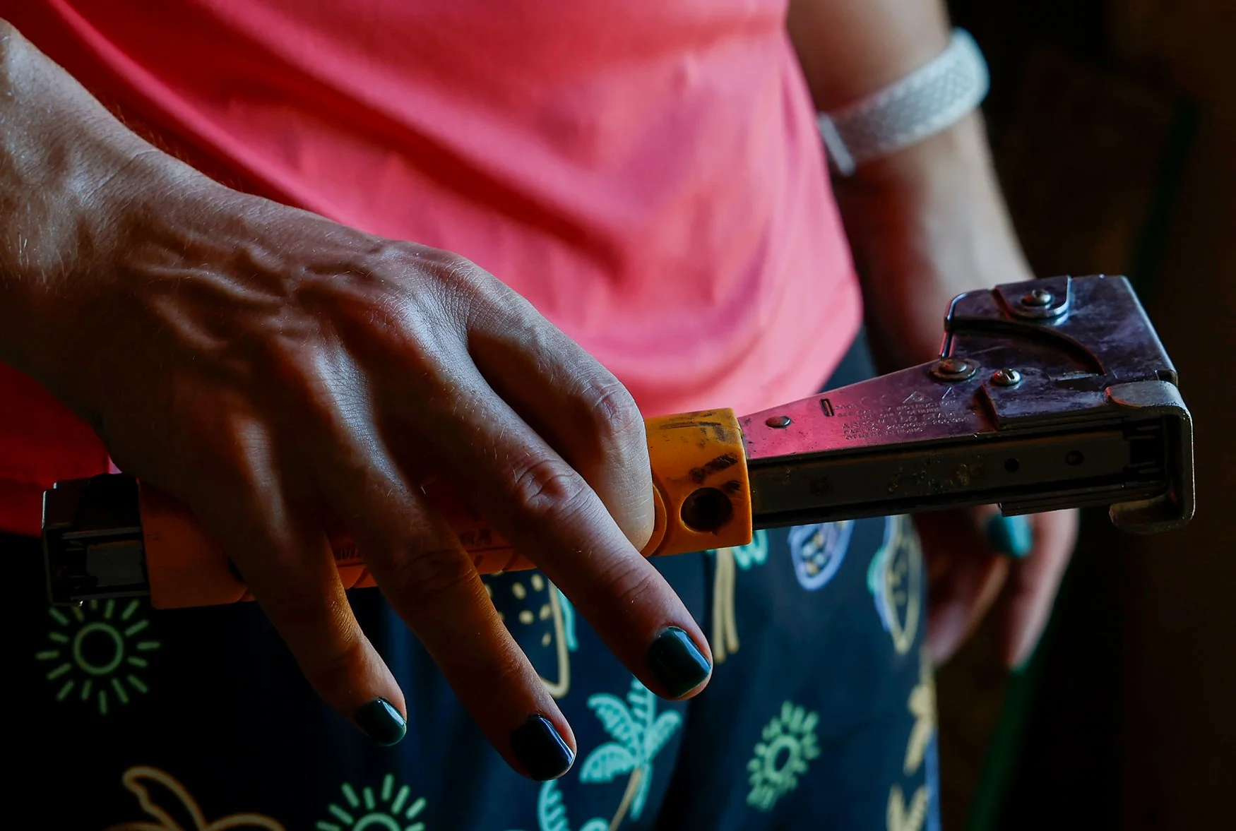 Thomas Moore shows off his nails Saturday while holding a hammer tacker during Pride Build. Including Moore, 37 volunteers were on the roster for the two-day event.