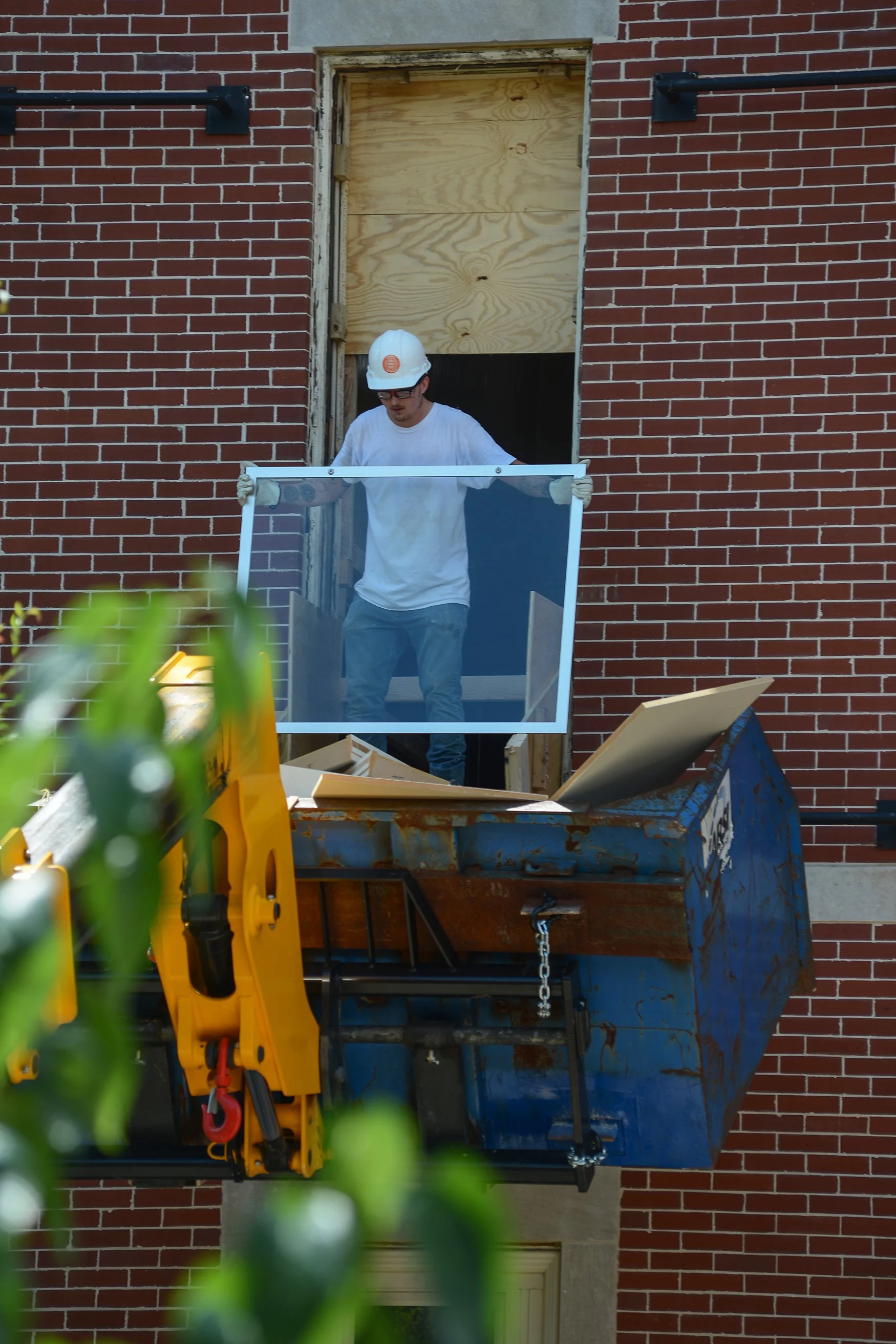 Zach Smith hauls a window pane out of Pickard Hall on the University of Missouri campus as part of the radioactive testing being pursued to settle the future of the building. Earlier plans for the building's demolition, which would cost approximately