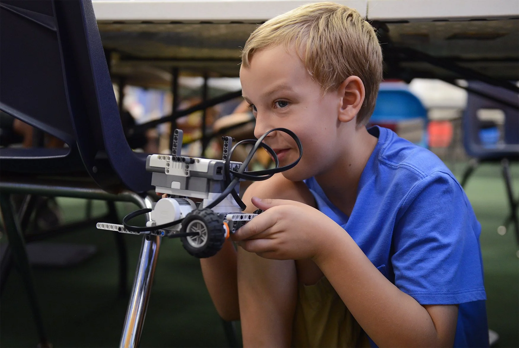 Calvin Percy, 9, holds up his robot during the Labspace Robotics class Monday at Capital Mall in Jefferson City. “My robot is called ‘Sumosaurus Rex,’” he said.