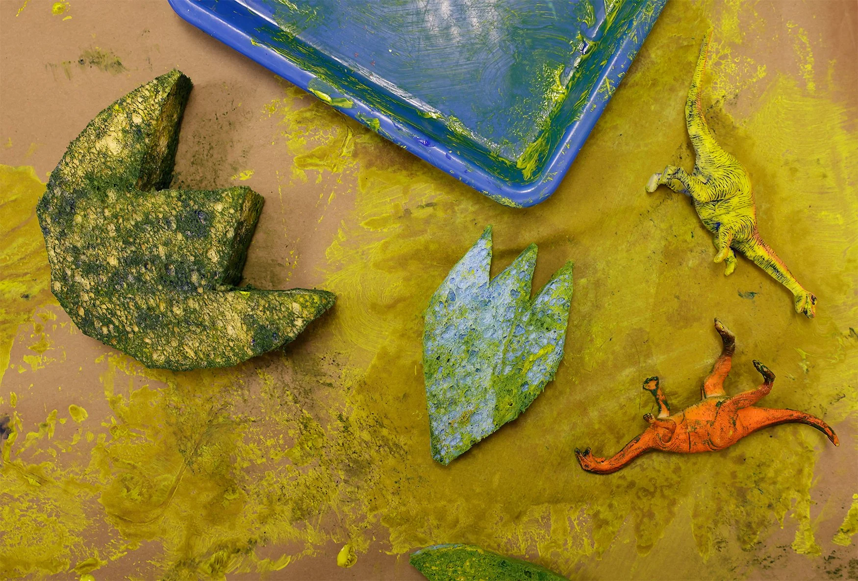 Paint-soaked sponges line the table during the Dino Summer Camp on Monday at the Tiny Play Cafe in Columbia. 2025 marked the second year the Tiny Play Caffe hosted a themed summer camp.