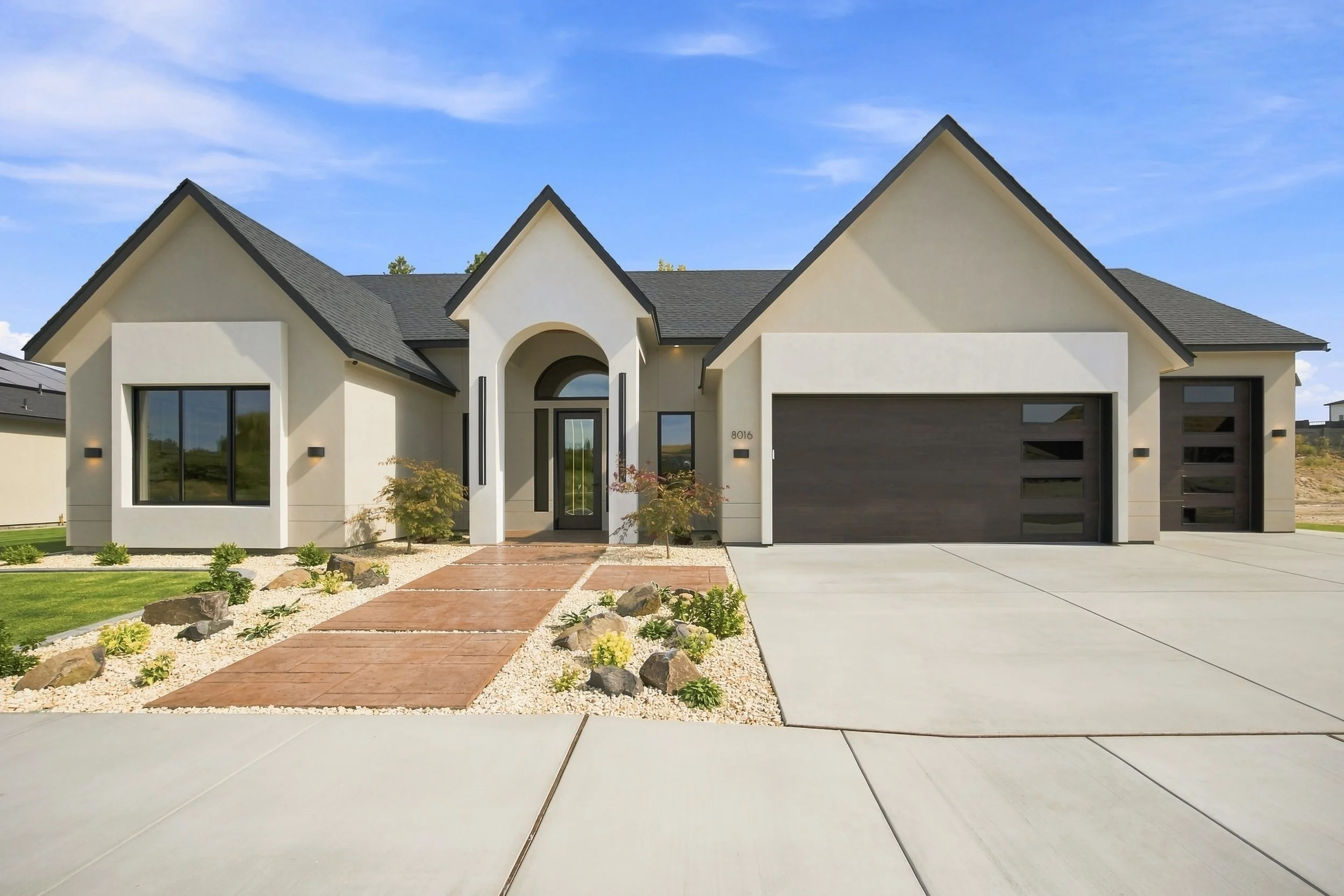 Modern European home with steep gables and an arched entry at Sculpted Elegance in Kennewick, Washington.