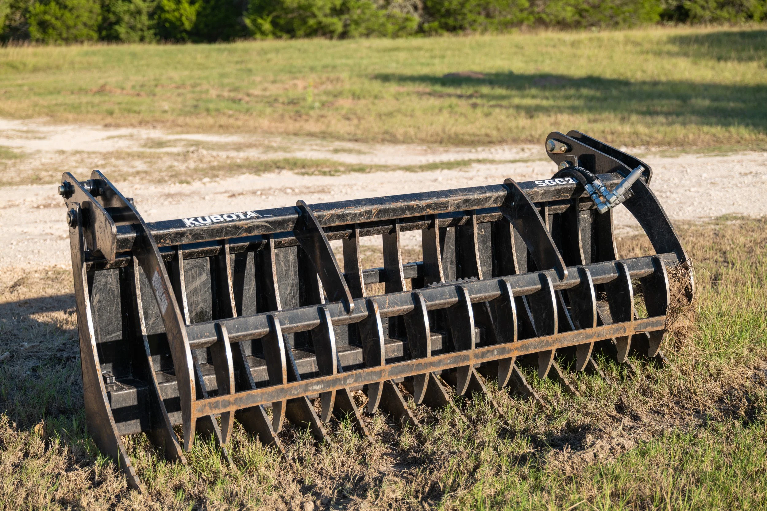 Heavy-duty grapple attachment for a tractor on grass