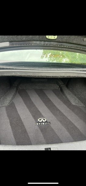 Car trunk interior with Infiniti logo on the carpet mat