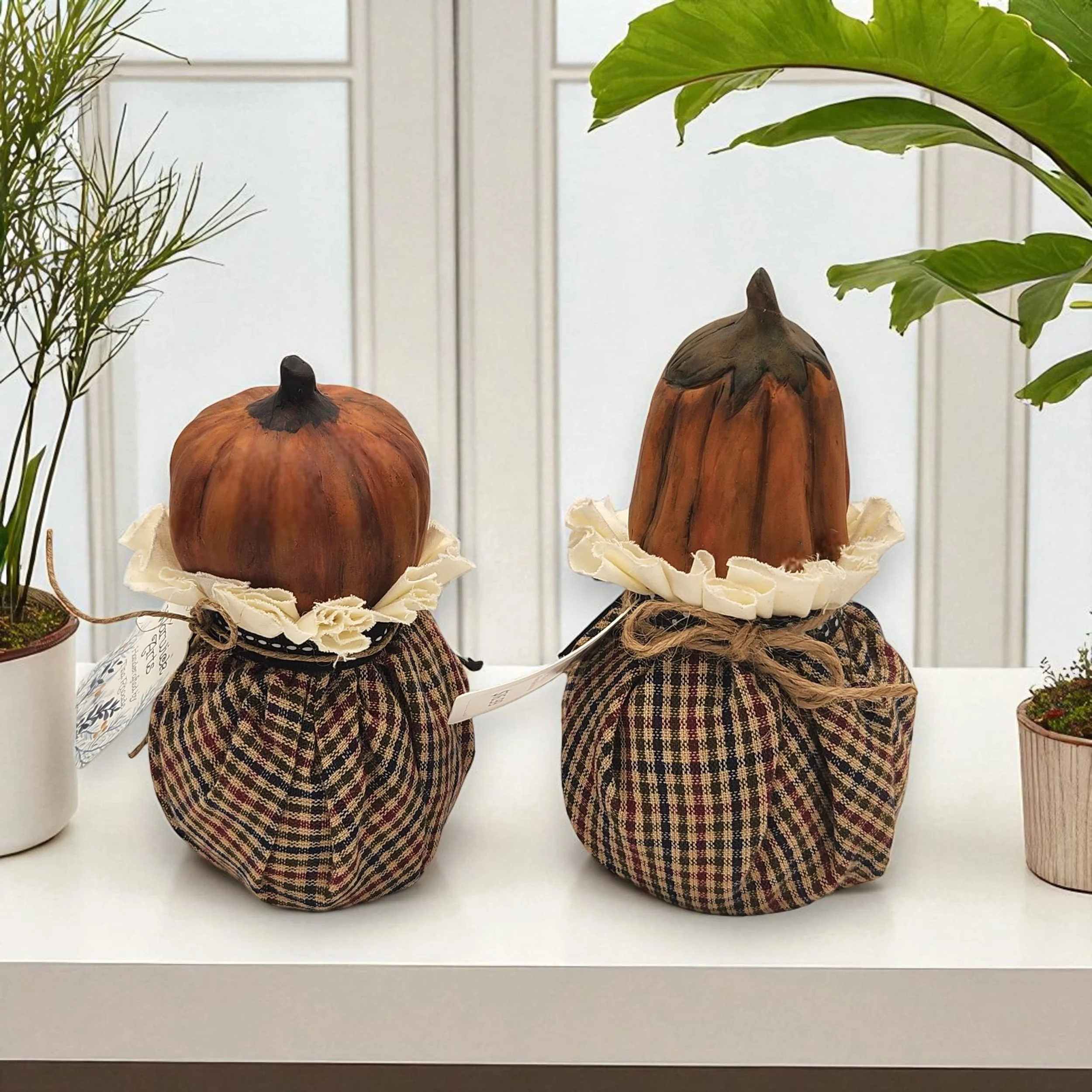 Rear view of the rustic pumpkin head, showing the smooth clay finish and gathered fabric base. The frayed collar and ribbon details wrap around, completing the old-world harvest look.