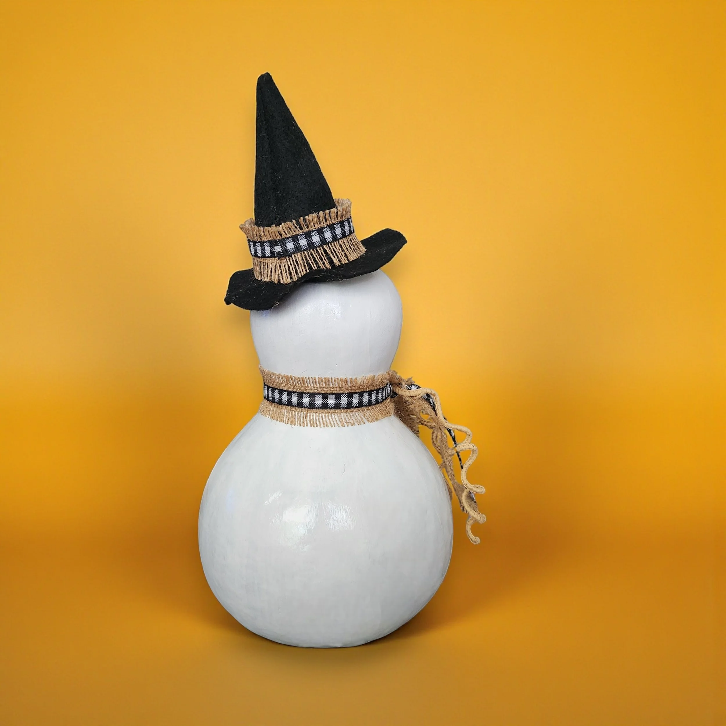 Back view of a bottle gourd ghost witch painted white with high gloss finish for durability.
