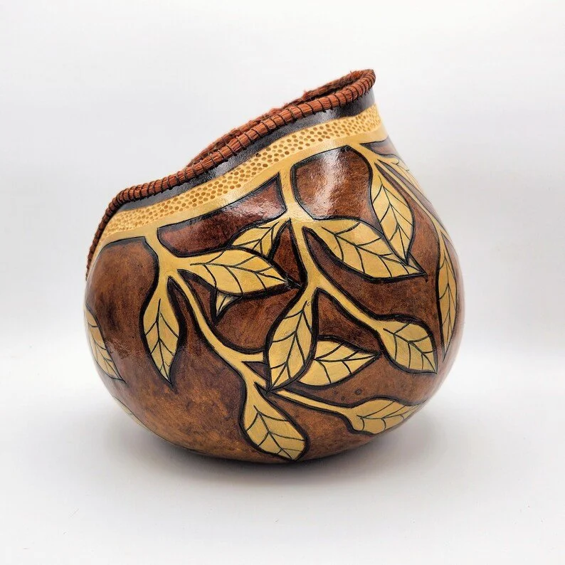 Side profile of rustic gourd bowl featuring a smooth curved base and engraved leaf design wrapping gently along the body.