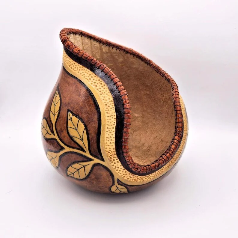 Artisan gourd bowl shown from a high side angle, emphasizing natural texture and hand-carved detailing.