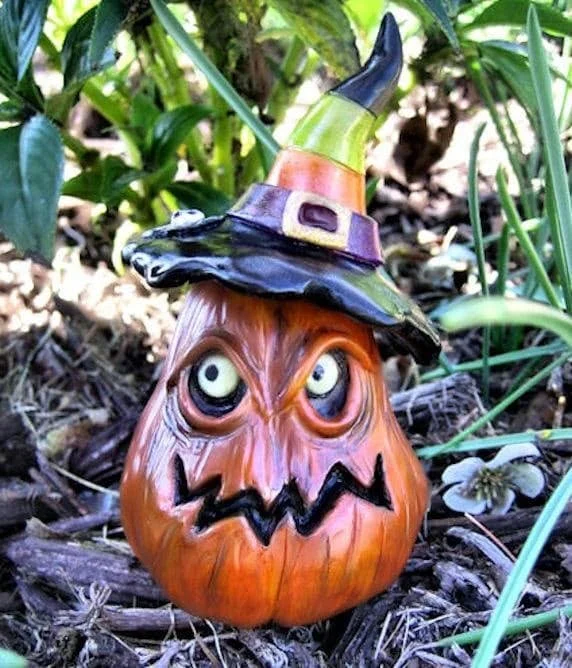 Detailed close-up of the pumpkin witch’s expressive face and hat, showing fine sculpting lines, hand-painted acrylics, and the playful spider detail on the brim.