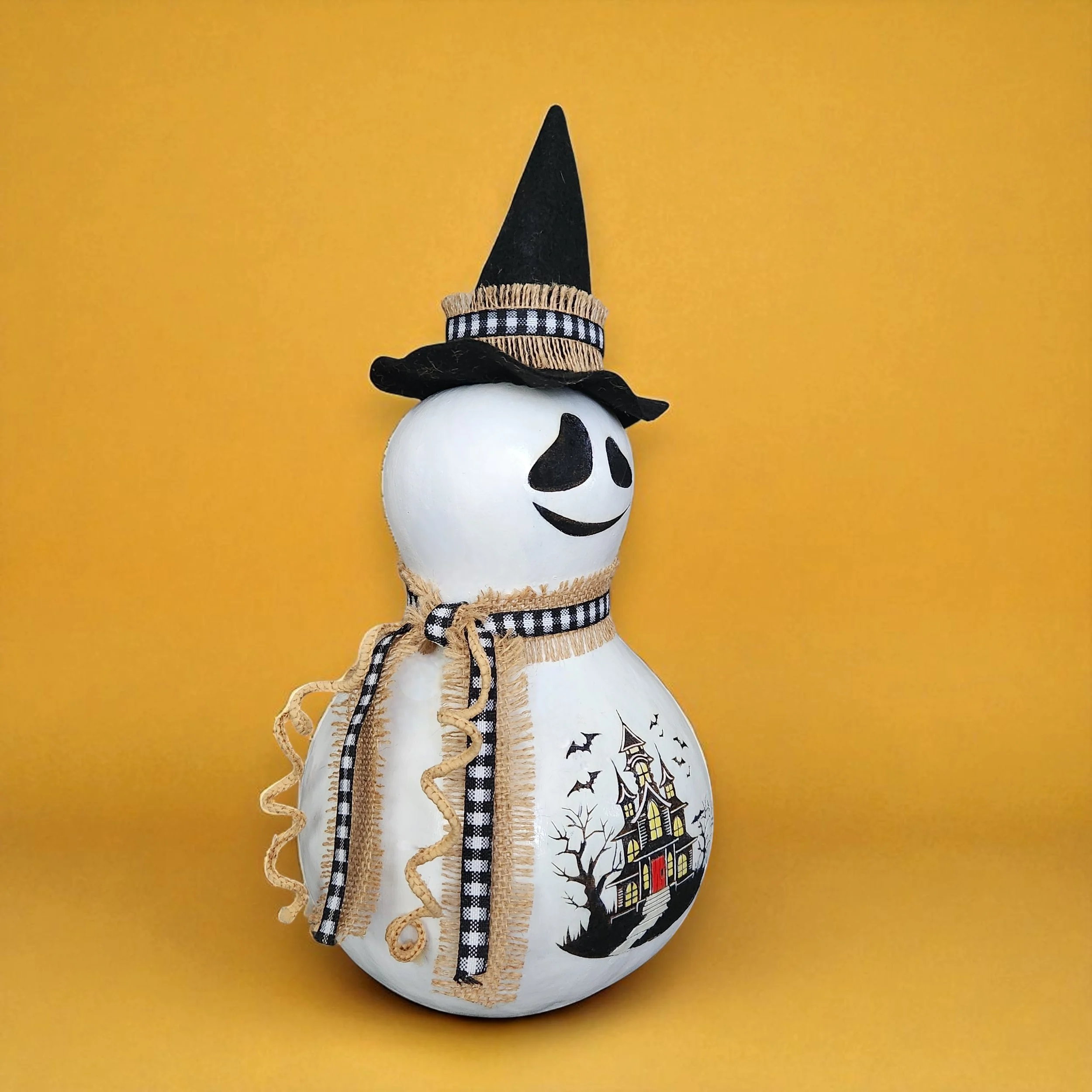 Side view of bottle gourd ghost witch with rustic ribbon and hat