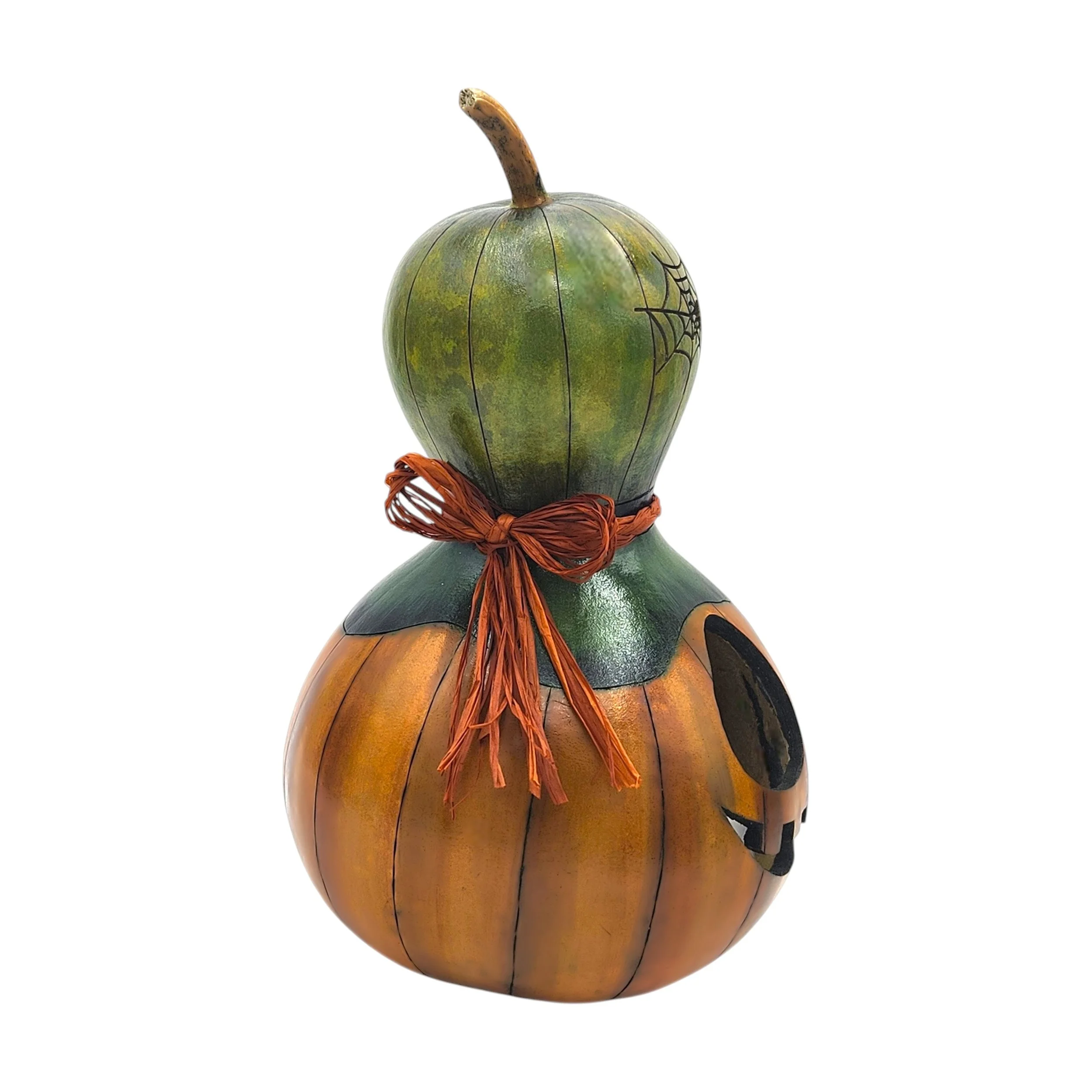 Detail of leafy green hat with rust-colored raffia bow and decorative spider web accent, adding whimsical Halloween charm.