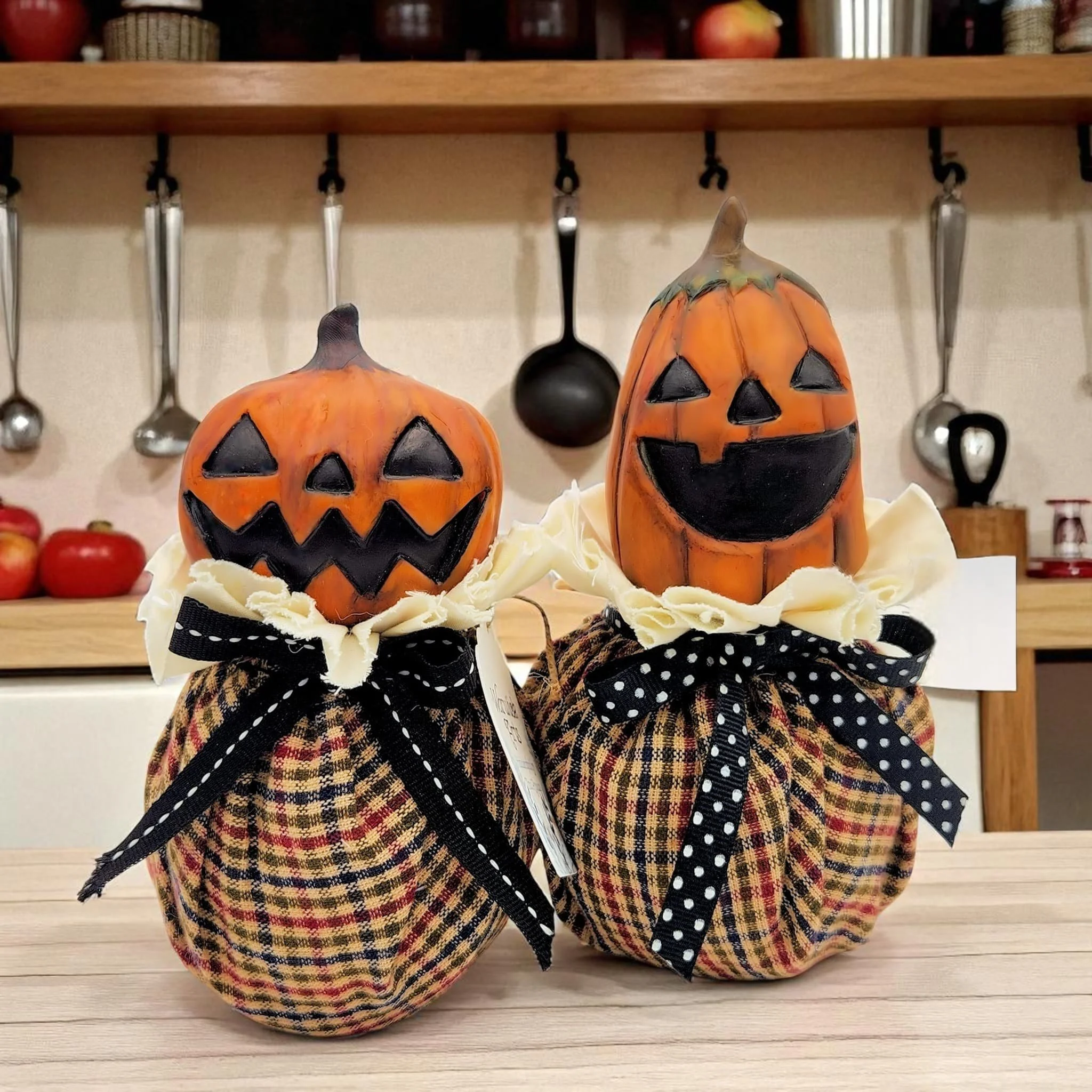 Detailed close-up of the pumpkin’s textured surface and whimsical facial features, showing brush-painted highlights, subtle aging effects, and the layered fabric accents around the neck.