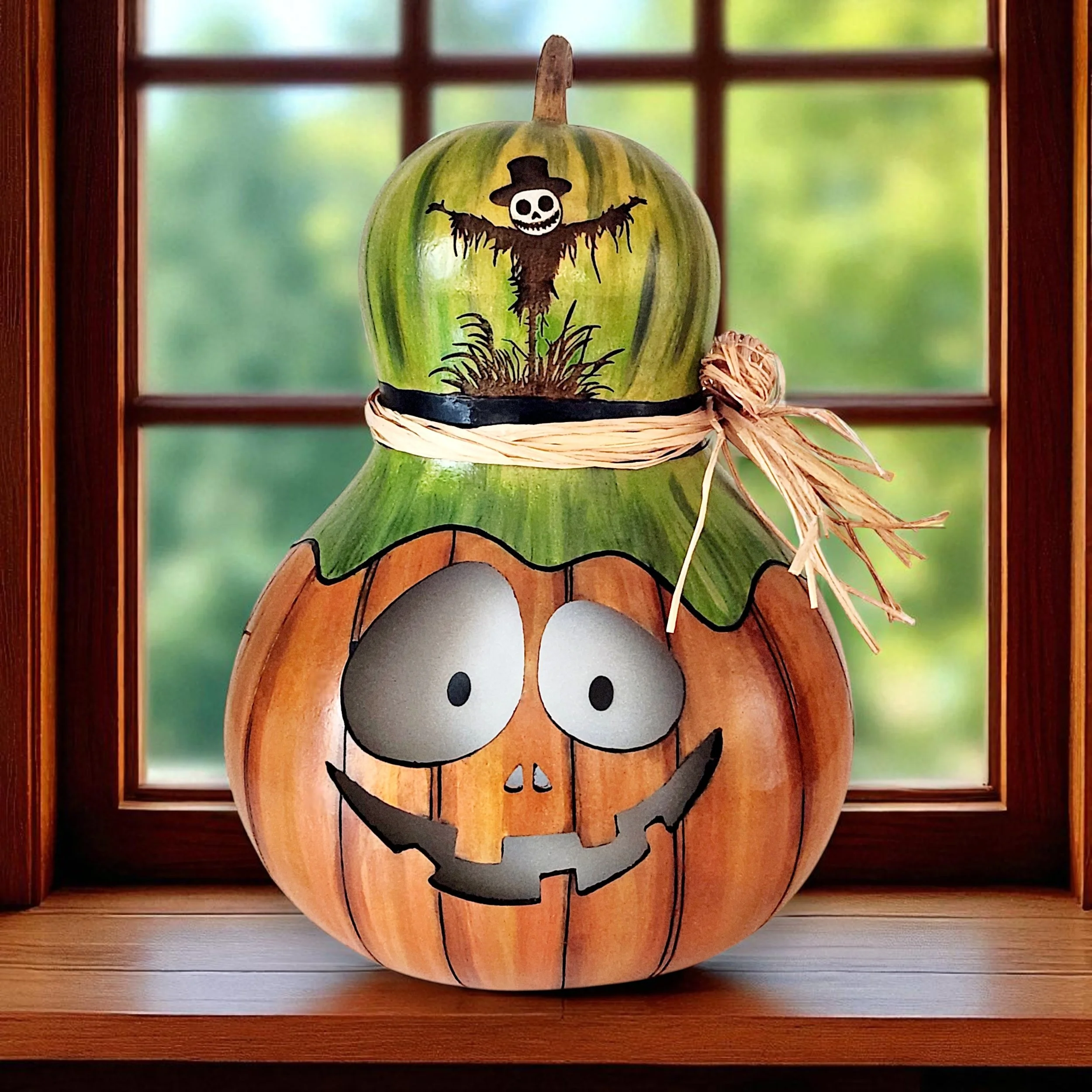 Closeup view of Pumpkin Scarecrow Jack-o-lantern with raffia bow and vellum insert to provide a beautiful glow when lit.