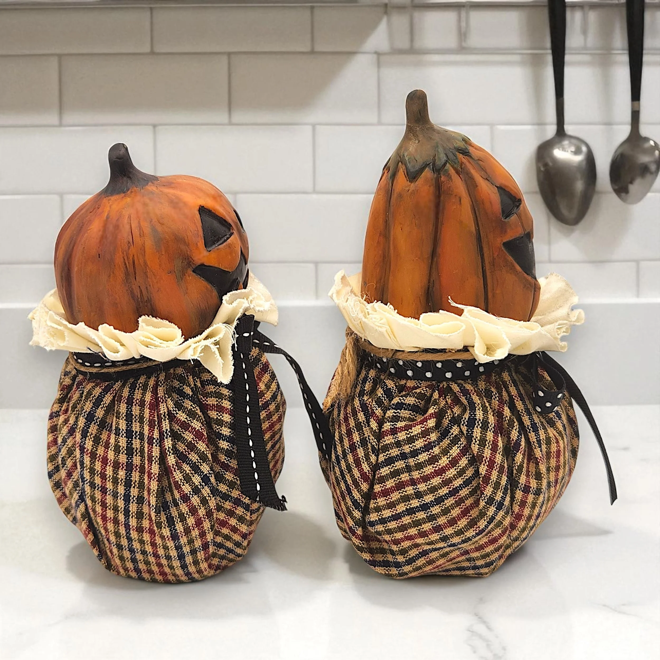 Three-quarter angled shot of the pumpkin figure, revealing its rounded shape, sculpted contours, and depth of character. The tilt emphasizes its handcrafted charm and playful posture.