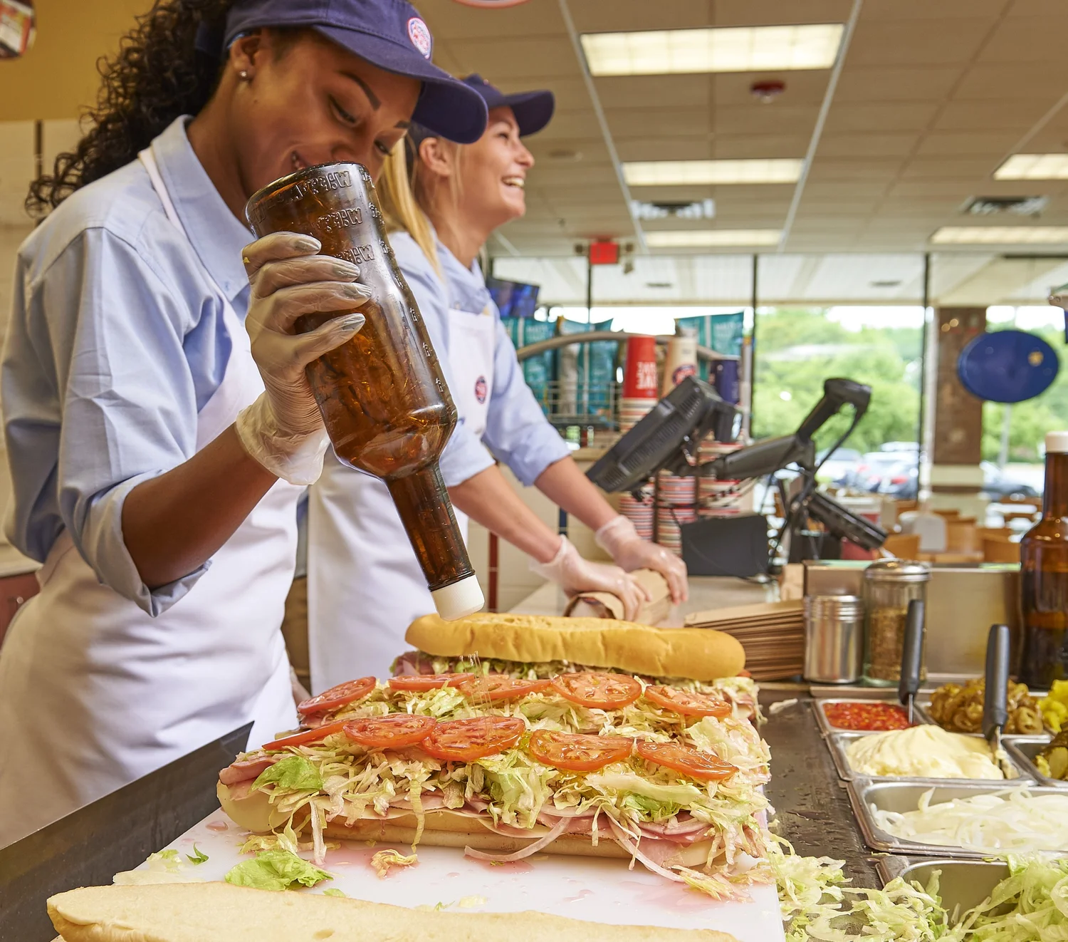 Jersey Mike's team members finishing a sub Mike's Way