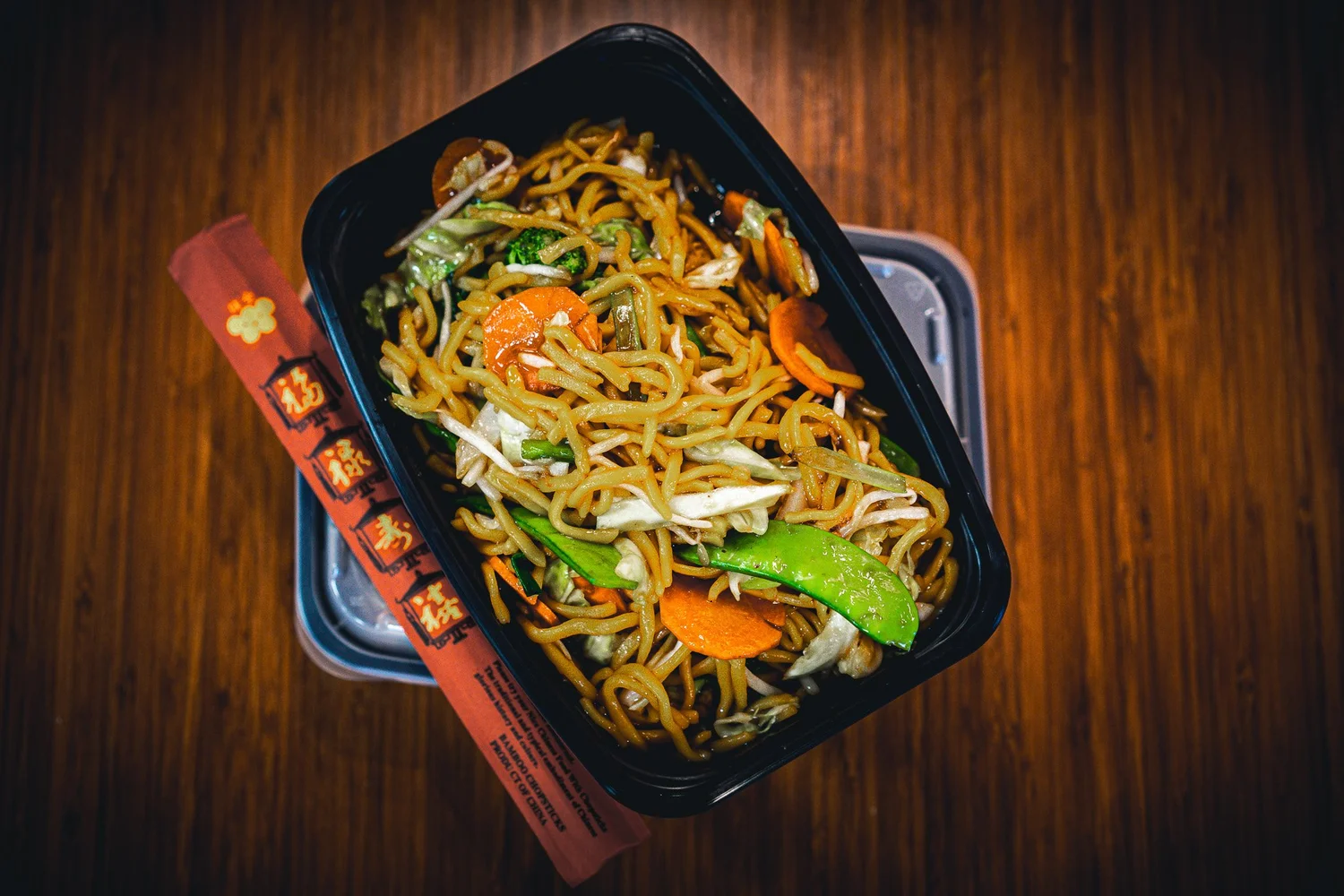 Magic Wok lo mein in a takeout bowl