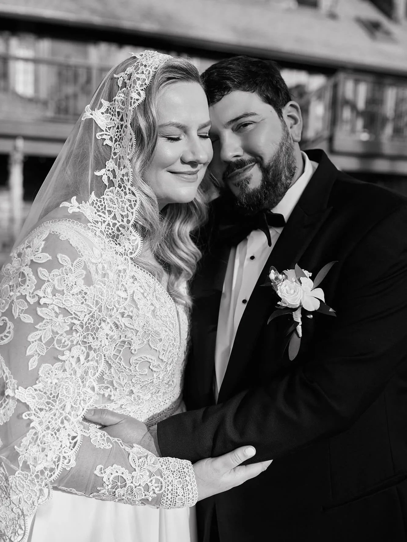 Close portrait of the bride and groom smiling, B&W