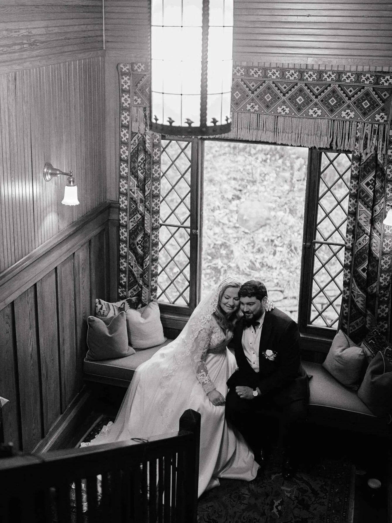 Romantic indoor portrait of couple sitting post-ceremony