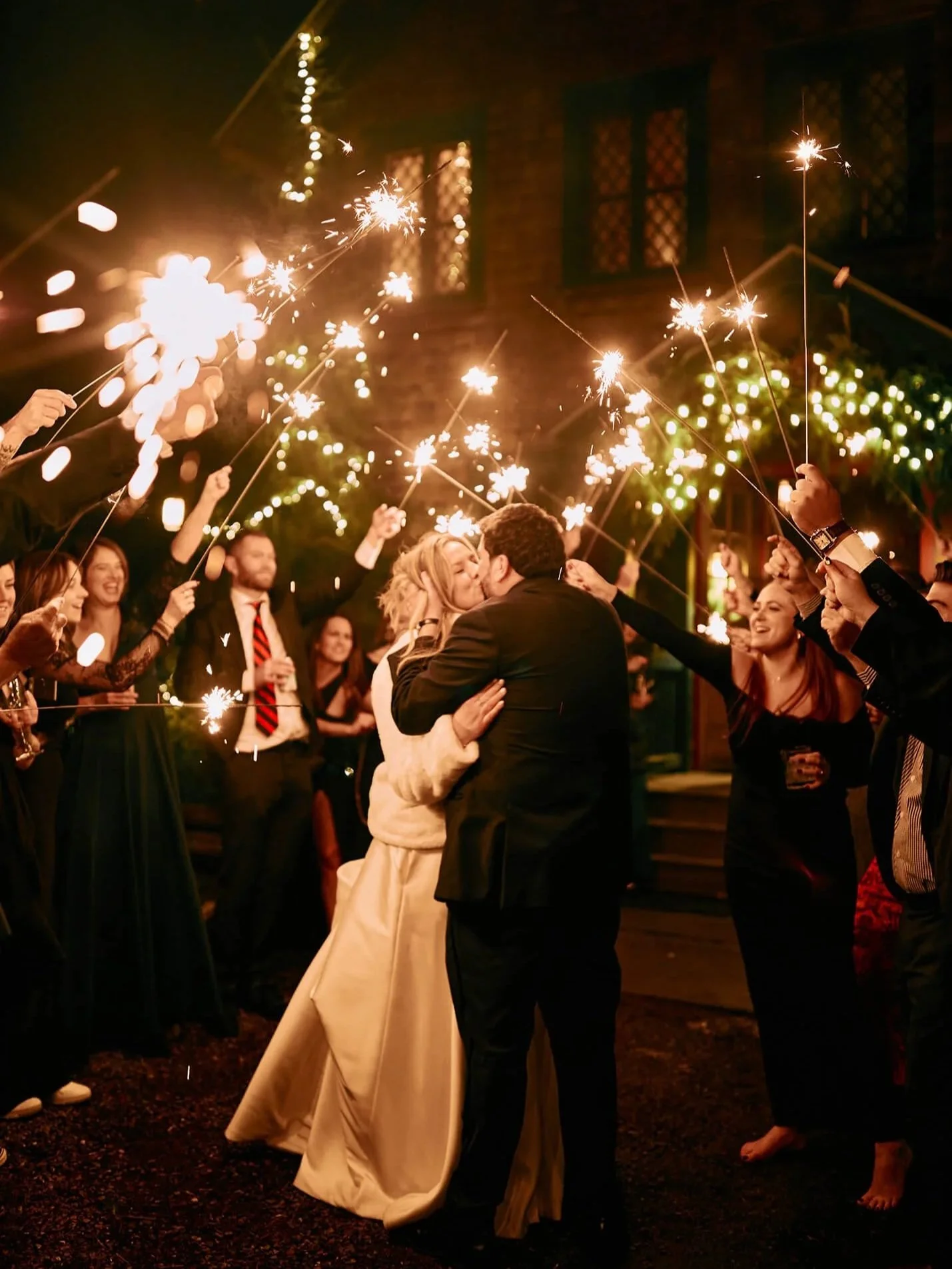 Surrounded by guests with sparklers during evening celebration