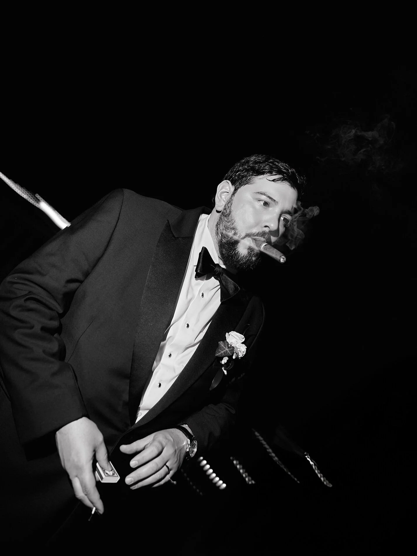 Groom smoking a cigar, cinematic flash moment