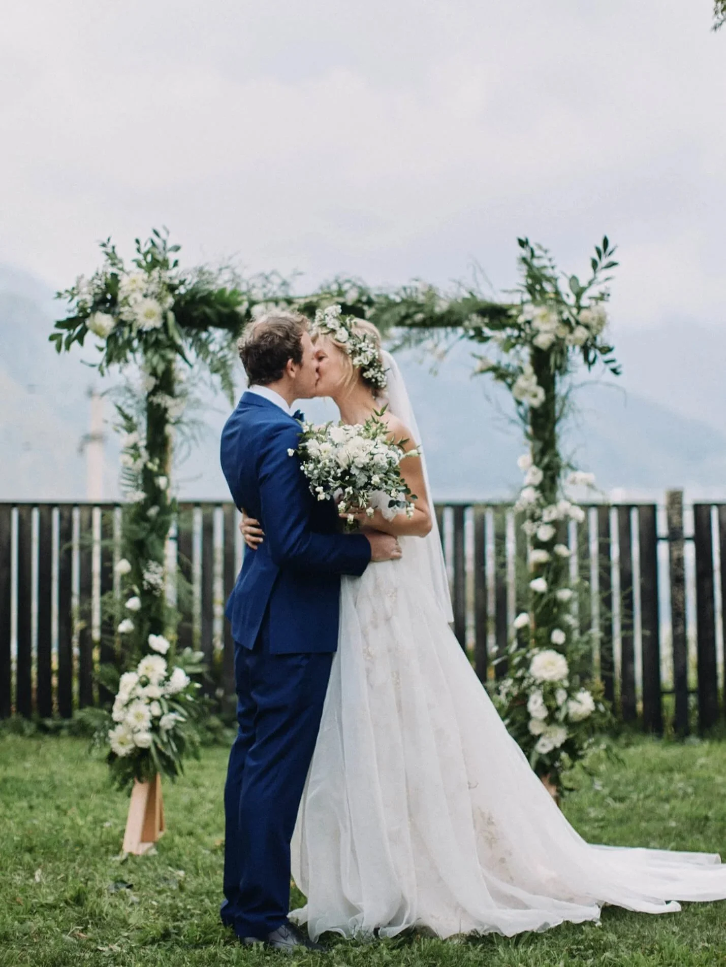 First kiss surrounded by guests