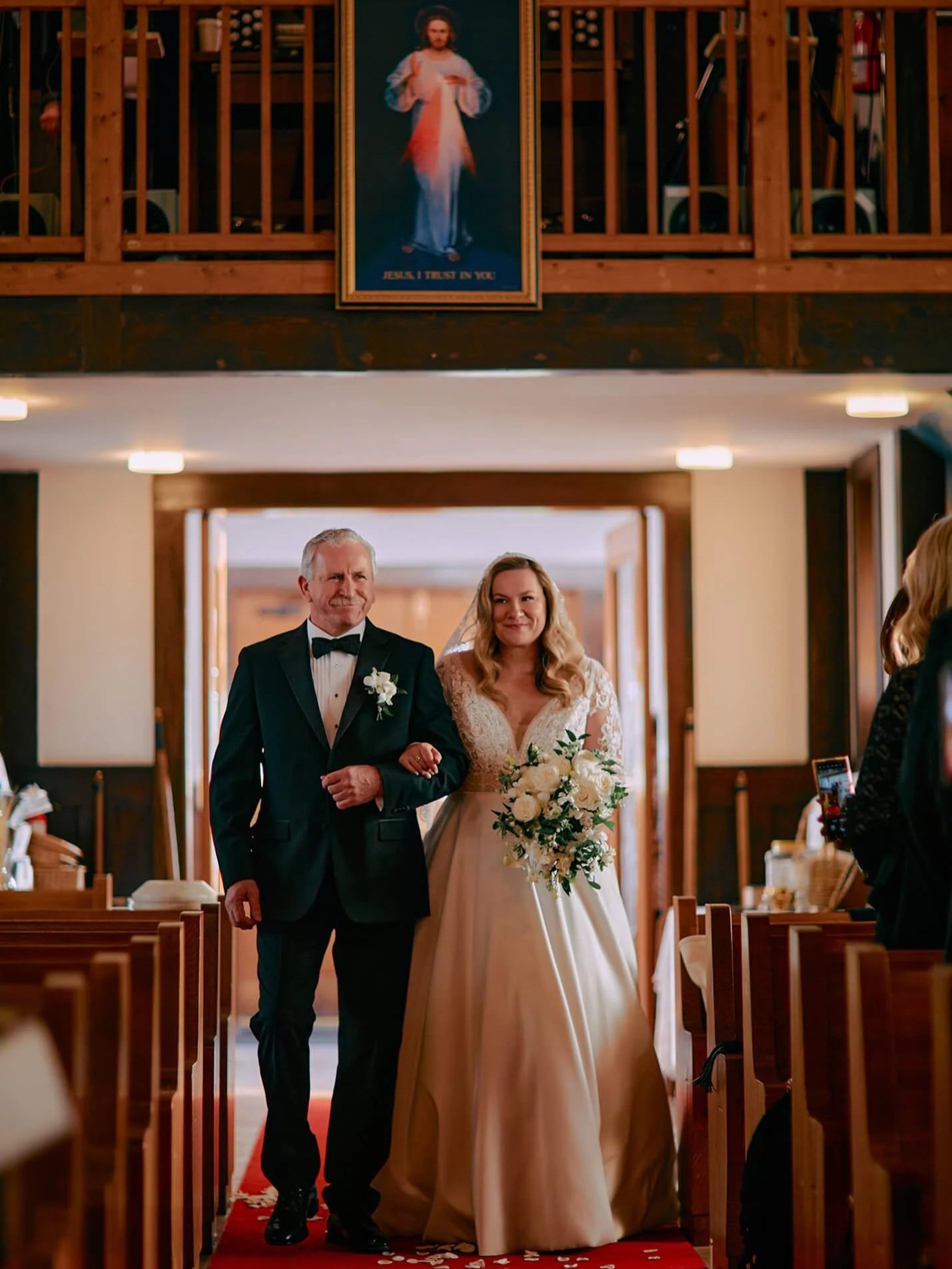 Bride escorted by father to the altar