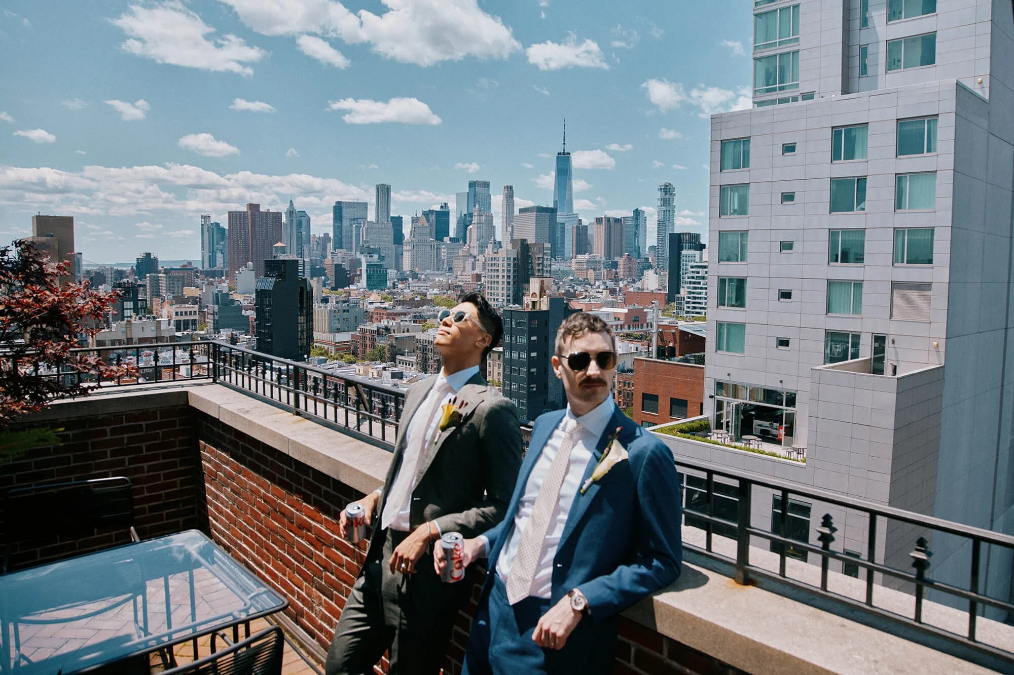 Grooms soaking up the sun with NYC skyline at Ludlow Hotel