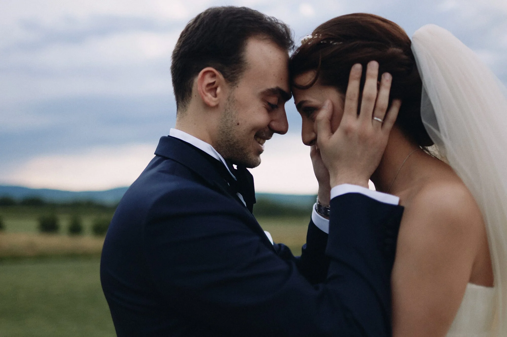 Wedding couple laughing, groom holding her head