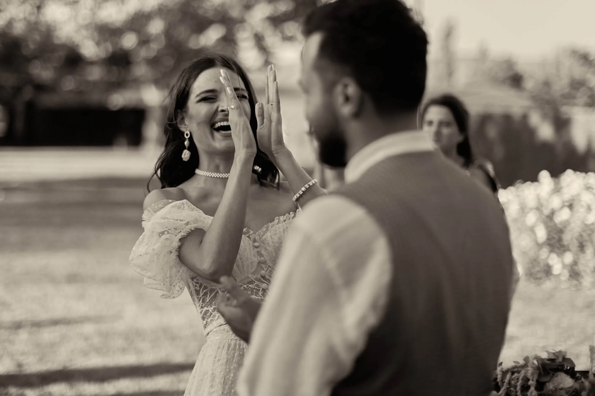 Candid moment of the bride and groom sharing a laugh during the ceremony